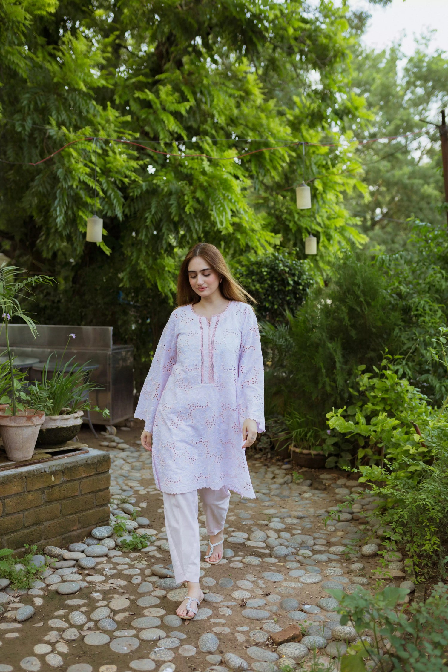 Elegant powder pink kurta featuring detailed Shifli Chikan cutwork and lace accents, complemented by a straight Khari Shalwar.