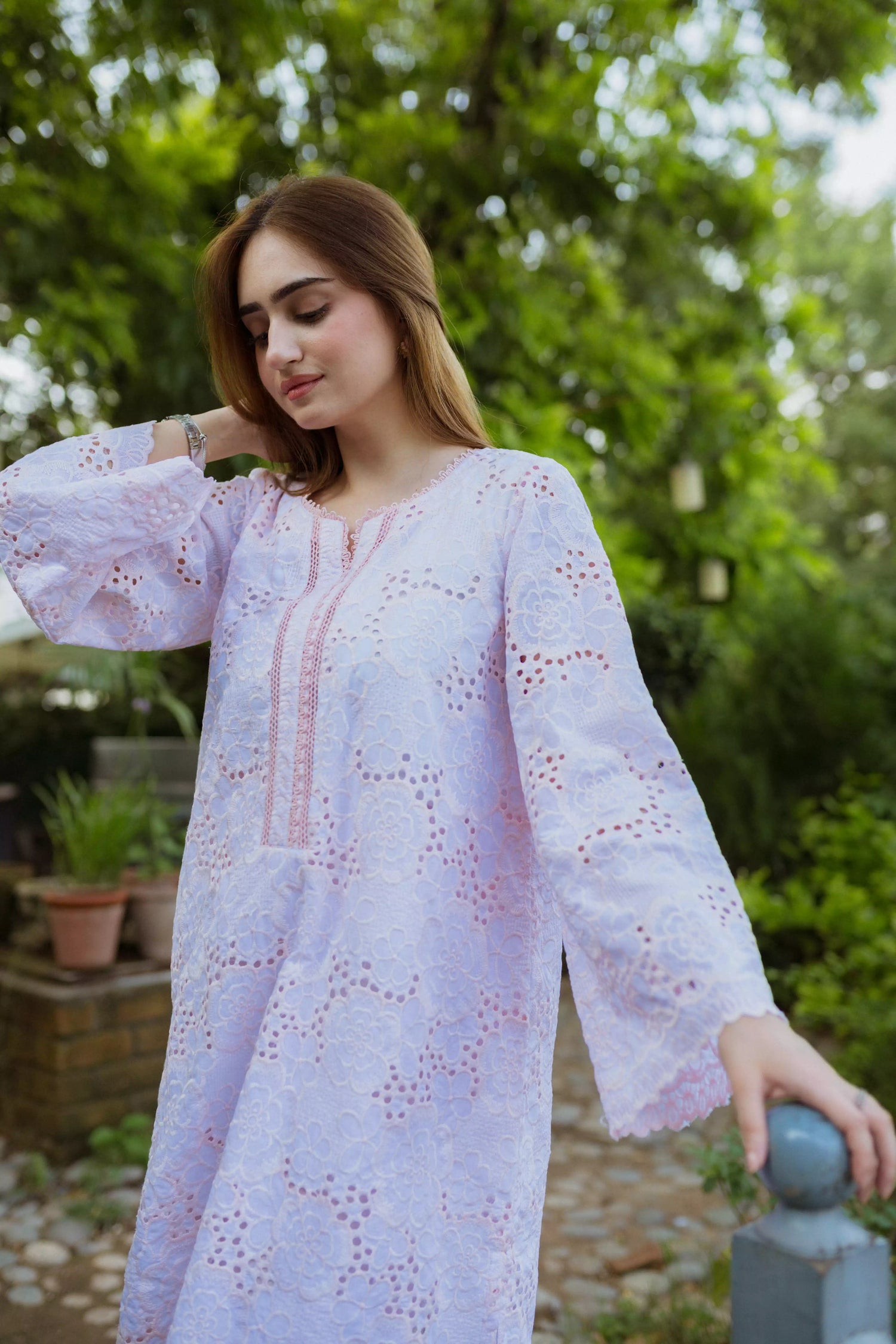 Elegant powder pink kurta featuring detailed Shifli Chikan cutwork and lace accents, complemented by a straight Khari Shalwar.