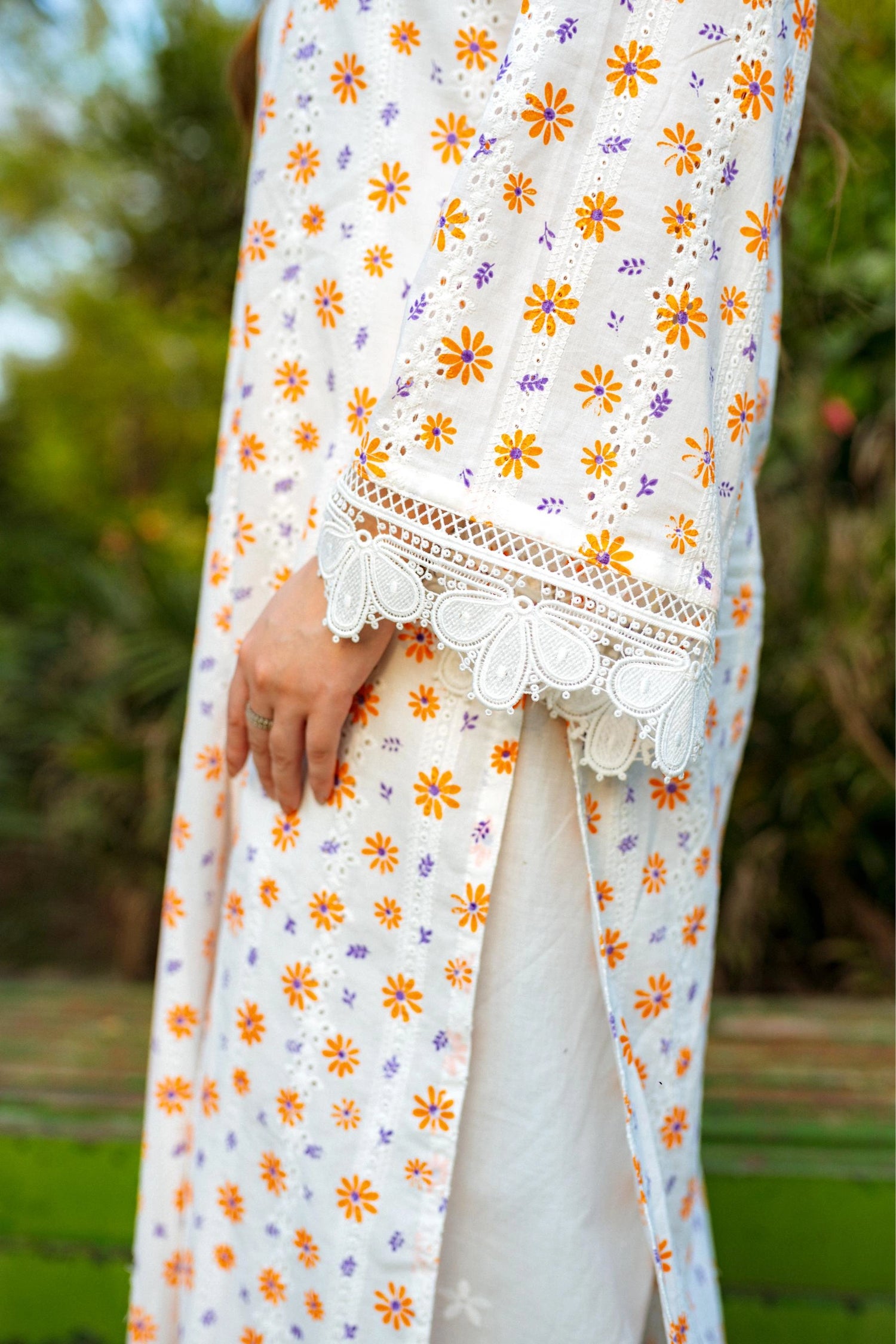 Floral White Chikan Kurta featuring a delicate floral pattern, lace neckline, and sleeve accents for a timeless and elegant look.