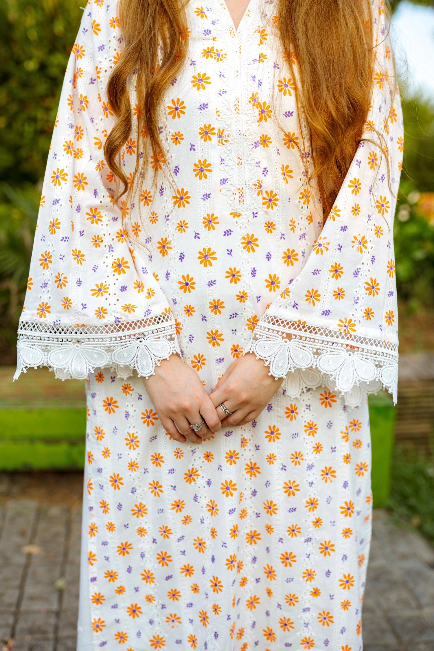 Floral White Chikan Kurta featuring a delicate floral pattern, lace neckline, and sleeve accents for a timeless and elegant look.