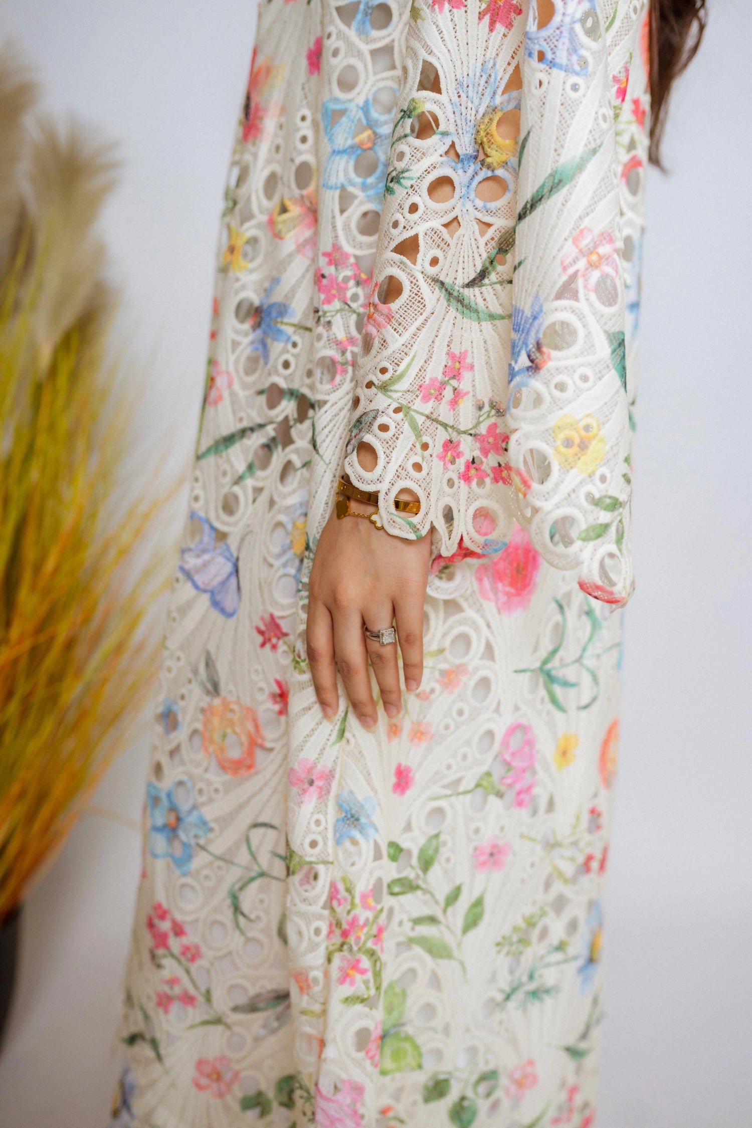 Multi-floral cutwork kaftan-style shirt with flared sleeves, featuring a vibrant design and relaxed, flowy fit for comfort.