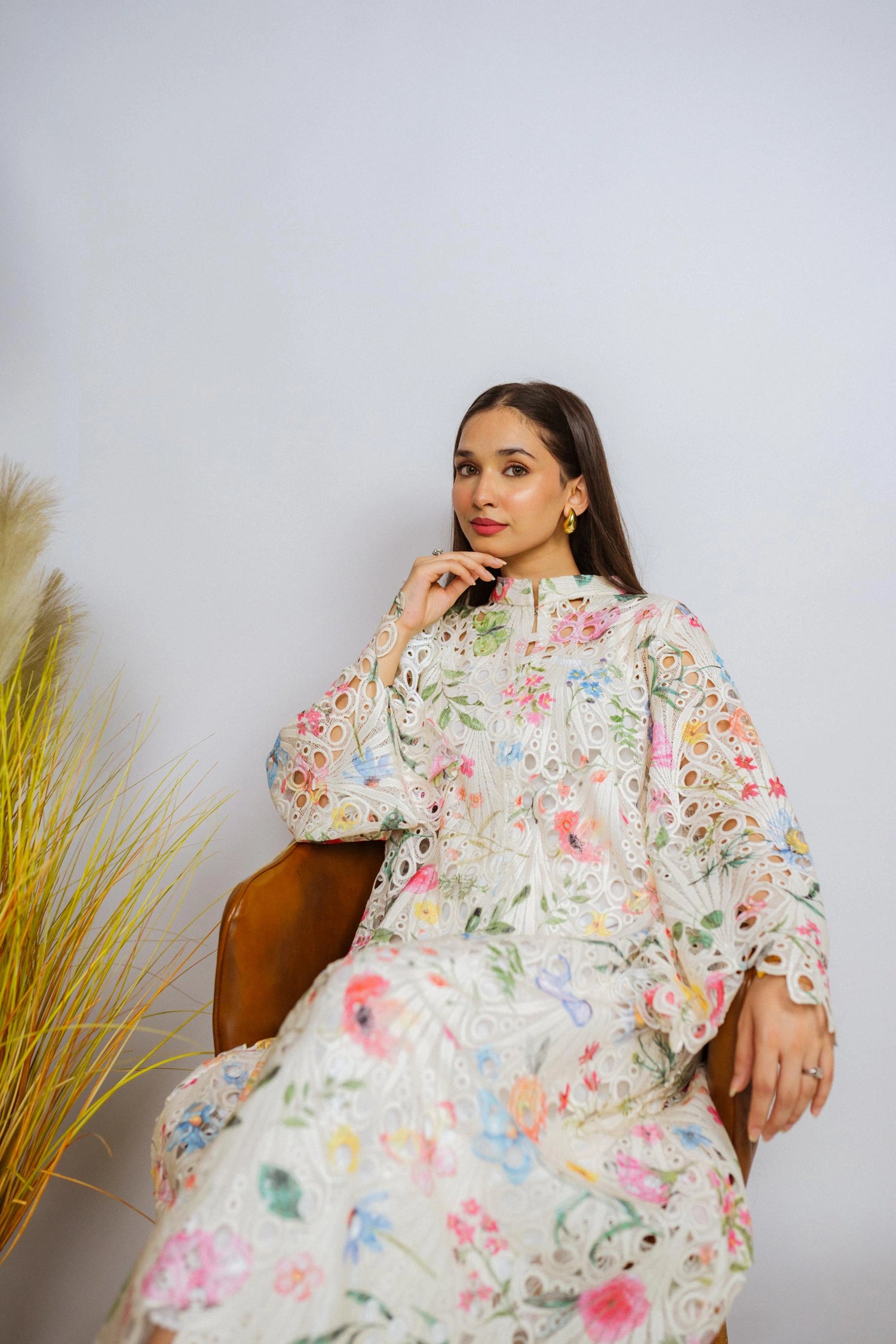 Multi-floral cutwork kaftan-style shirt with flared sleeves, featuring a vibrant design and relaxed, flowy fit for comfort.