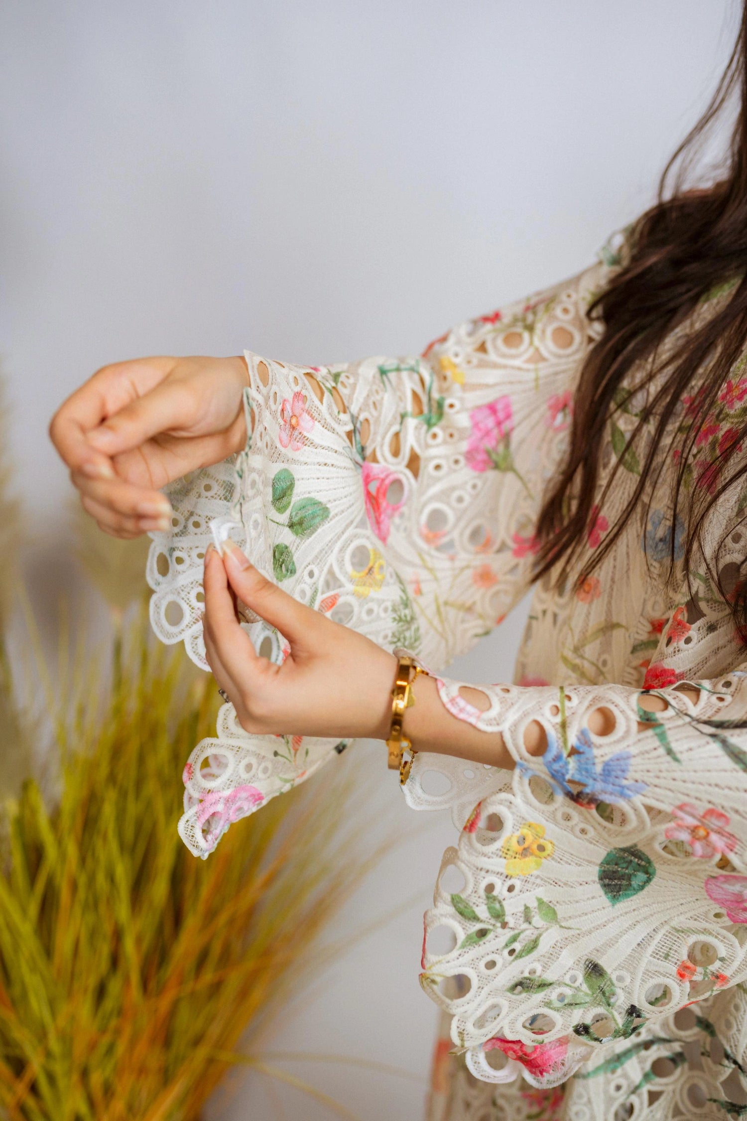 Multi-floral cutwork kaftan-style shirt with flared sleeves, featuring a vibrant design and relaxed, flowy fit for comfort.