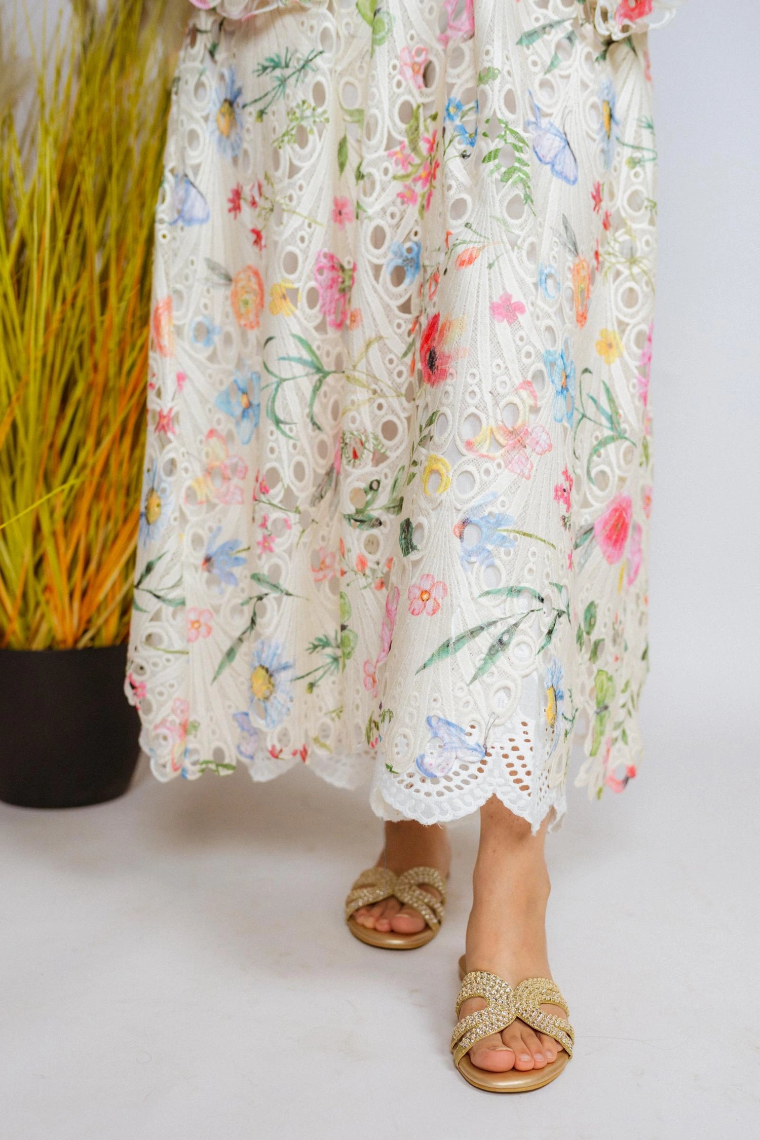 Multi-floral cutwork kaftan-style shirt with flared sleeves, featuring a vibrant design and relaxed, flowy fit for comfort.