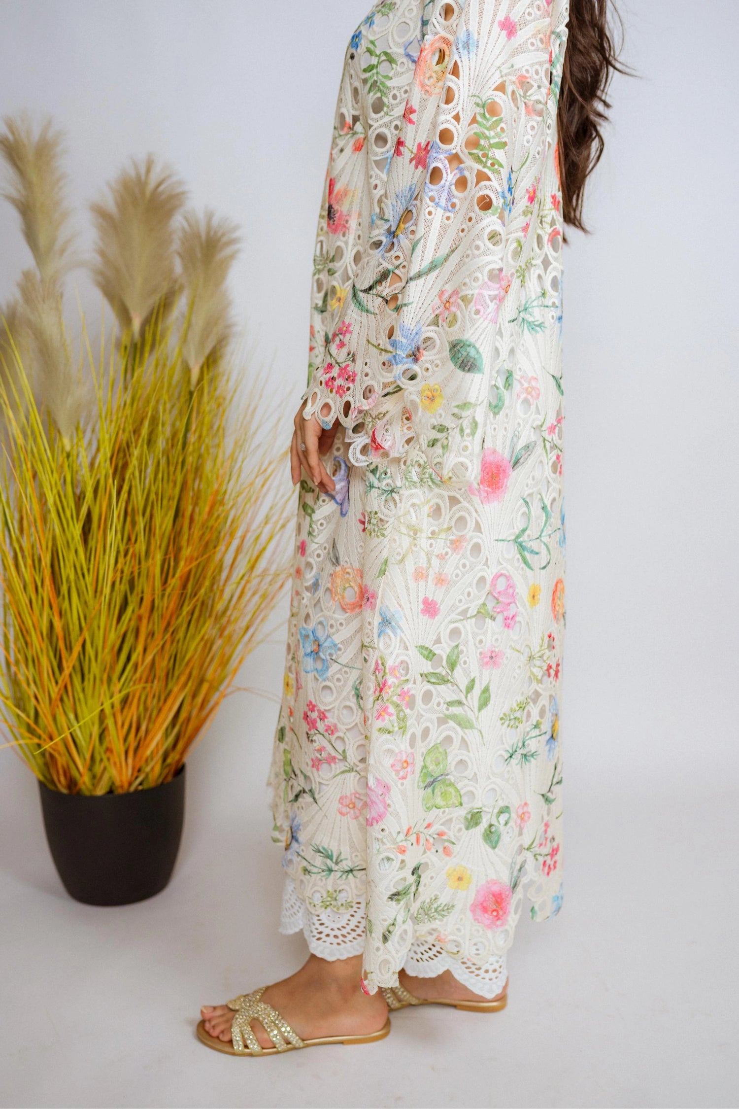 Multi-floral cutwork kaftan-style shirt with flared sleeves, featuring a vibrant design and relaxed, flowy fit for comfort.