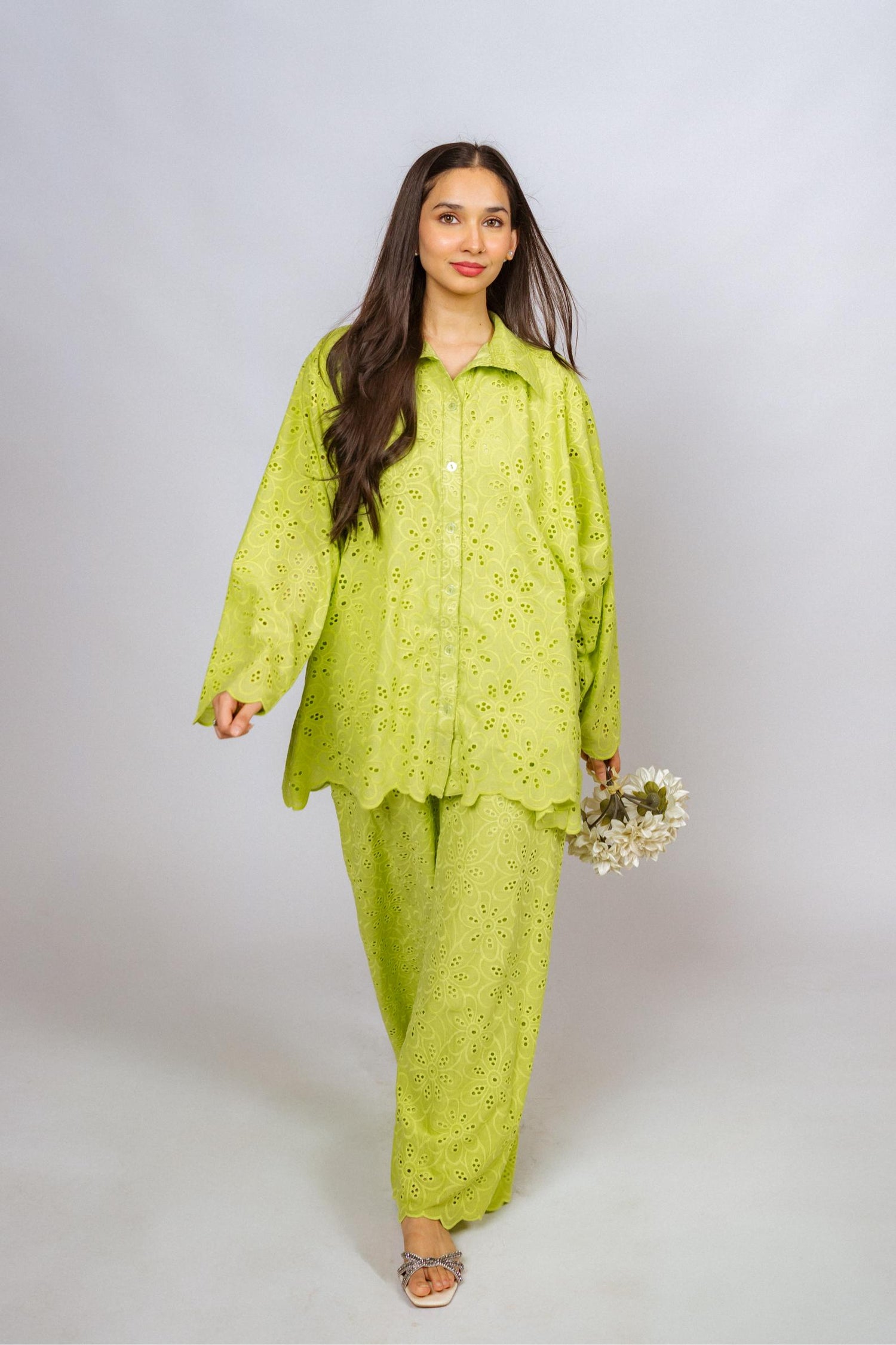 Vibrant parrot green kurta and flared pants set with detailed Shifli Chikan embroidery, offering a stylish and elegant silhouette.