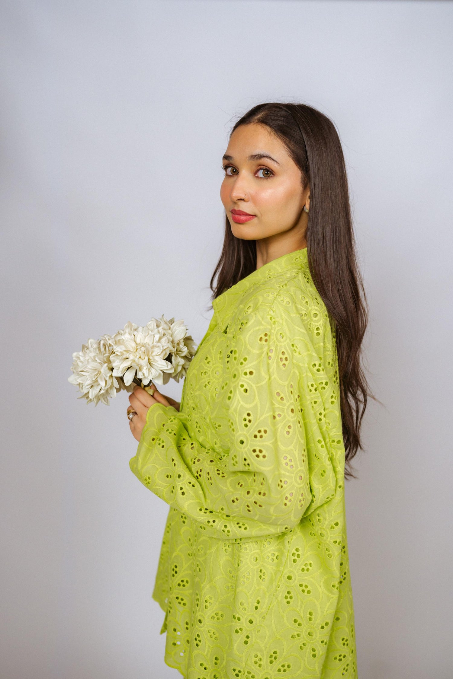 Vibrant parrot green kurta and flared pants set with detailed Shifli Chikan embroidery, offering a stylish and elegant silhouette.