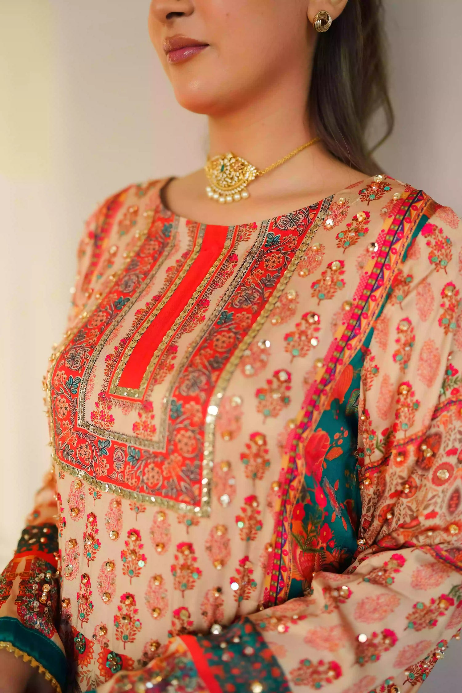 Discover festive kurta crafted from premium silk with warm floral prints and delicate hand-finished embellishments, featuring a smooth, lightweight drape that blends traditional elegance with contemporary style for special occasions.