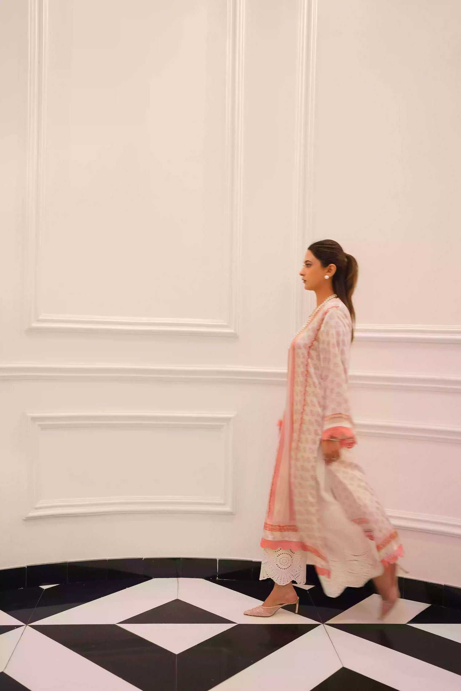 White and blush-pink silk kurta with delicate floral motifs and subtle hand-finished embellishments, featuring a lightweight, flowing drape that creates an elegant silhouette, ideal for Eid and festive daytime celebrations.