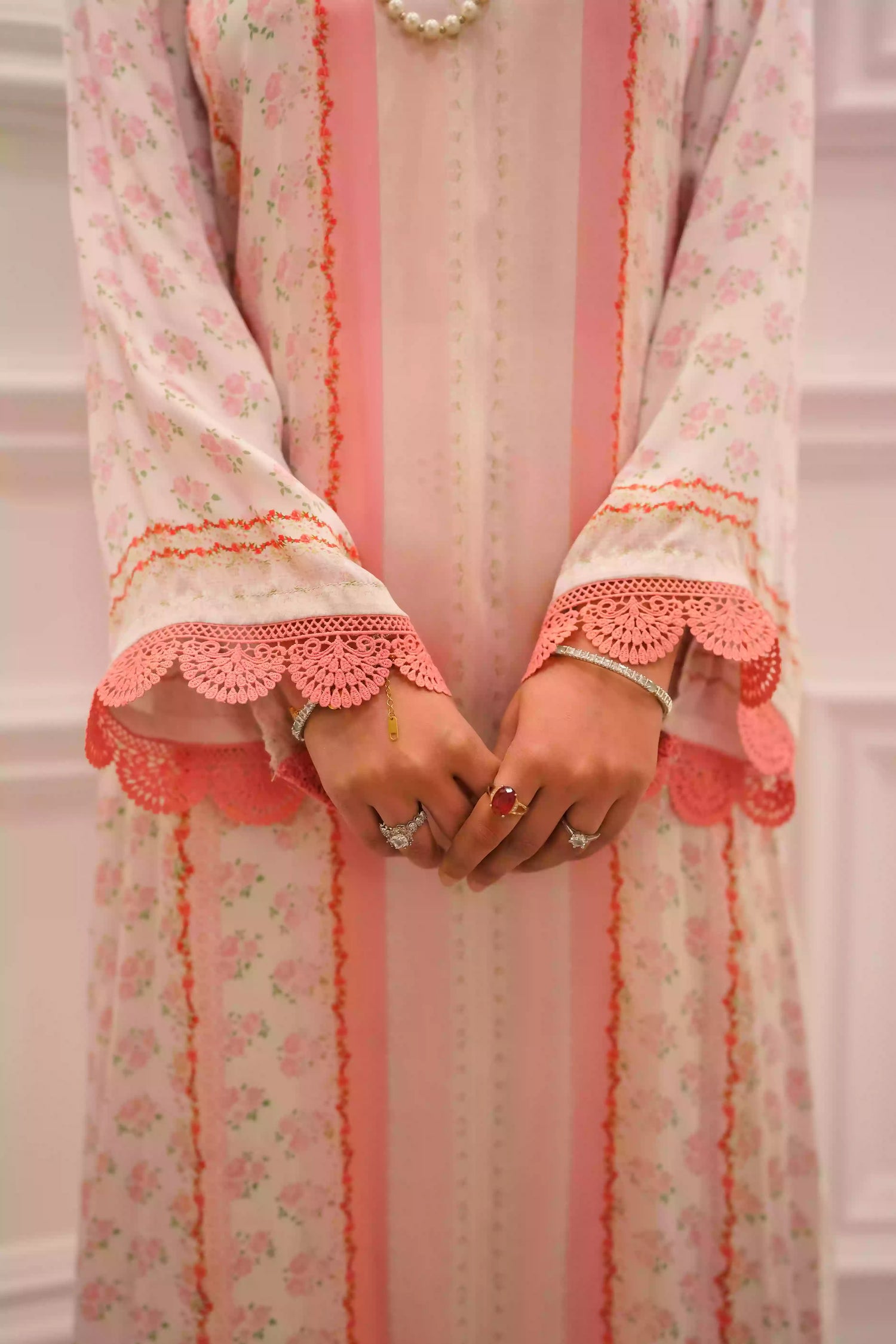 White and blush-pink silk kurta with delicate floral motifs and subtle hand-finished embellishments, featuring a lightweight, flowing drape that creates an elegant silhouette, ideal for Eid and festive daytime celebrations.