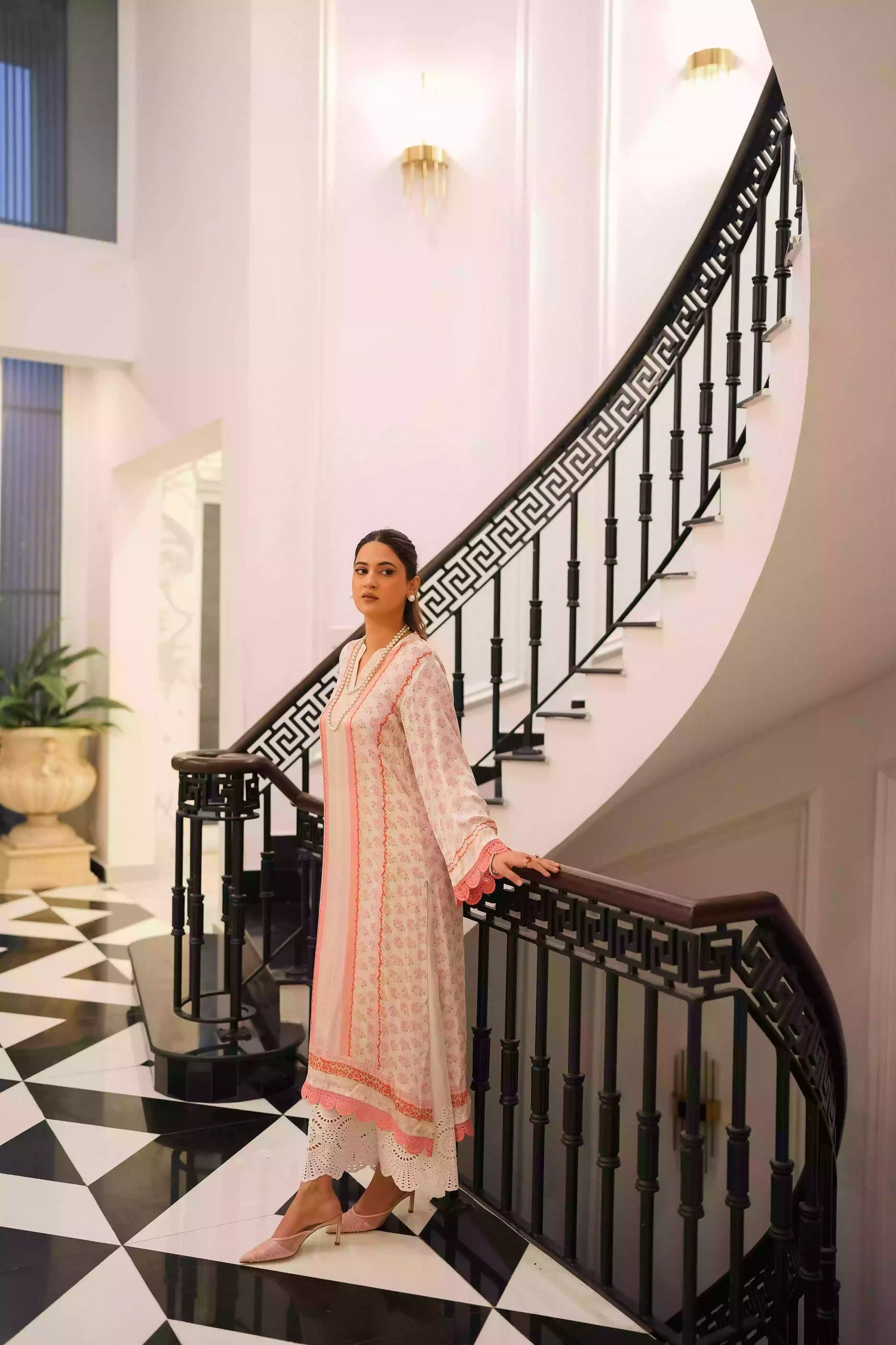 White and blush-pink silk kurta with delicate floral motifs and subtle hand-finished embellishments, featuring a lightweight, flowing drape that creates an elegant silhouette, ideal for Eid and festive daytime celebrations.