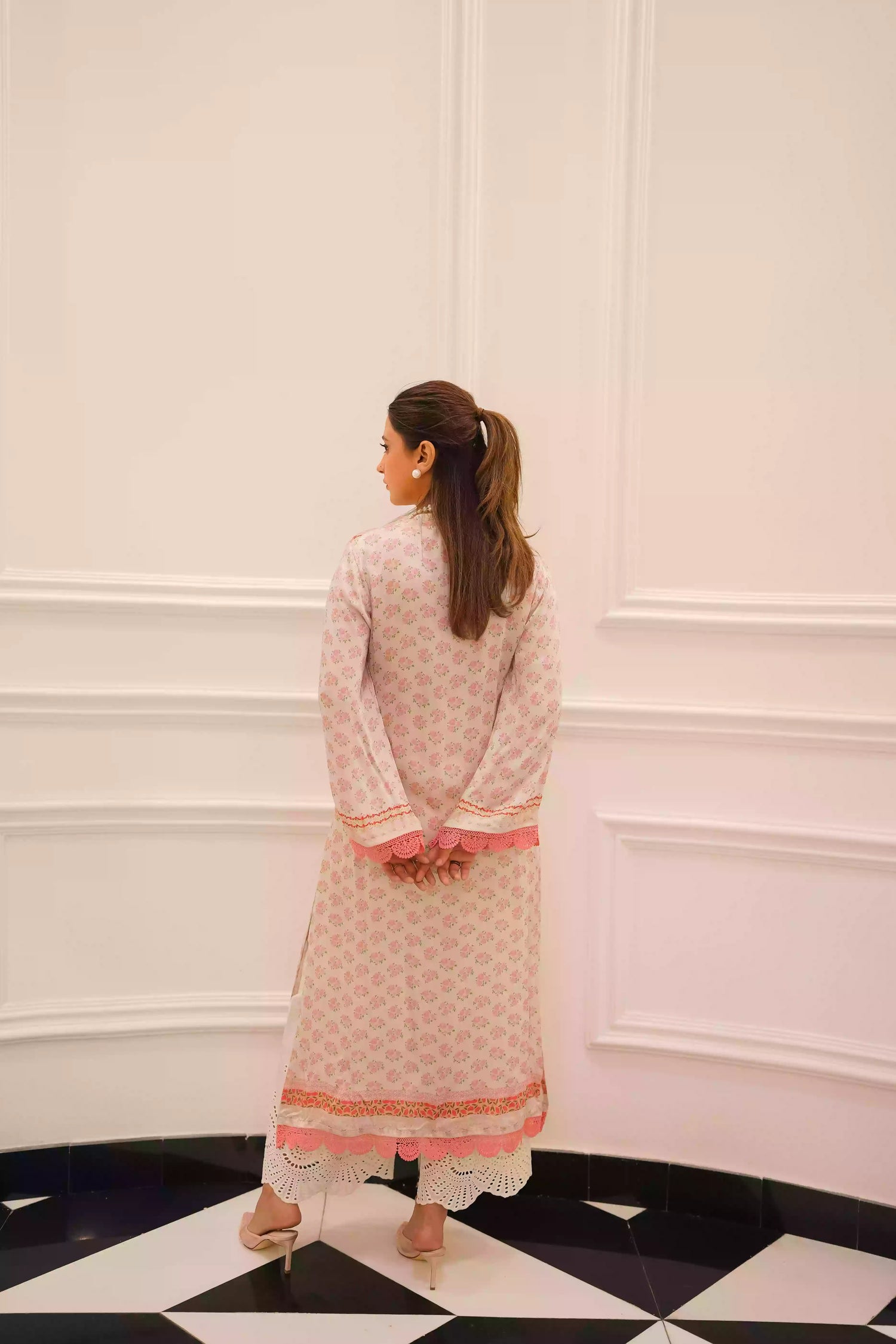 White and blush-pink silk kurta with delicate floral motifs and subtle hand-finished embellishments, featuring a lightweight, flowing drape that creates an elegant silhouette, ideal for Eid and festive daytime celebrations.