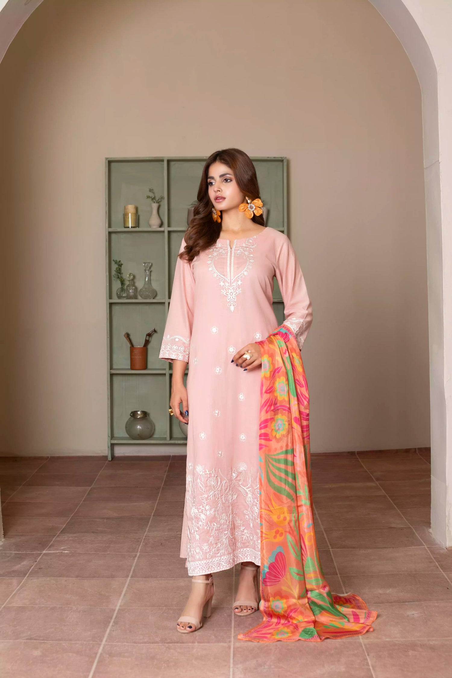 Soft pink embroidered suit with white floral motifs, matching trousers, and a vibrant multicolor silk dupatta for summer elegance.
