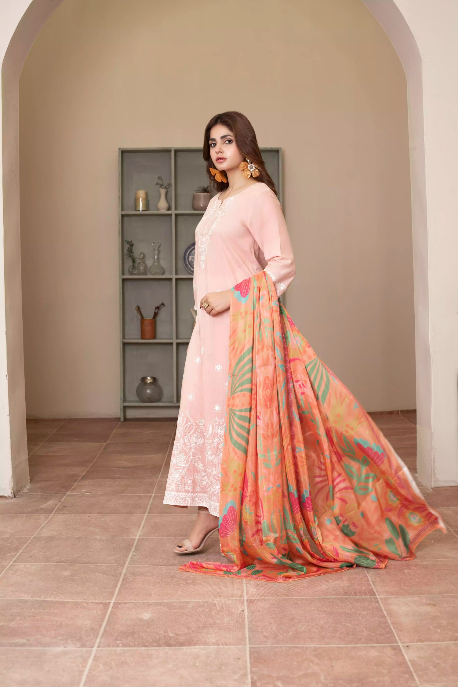 Soft pink embroidered suit with white floral motifs, matching trousers, and a vibrant multicolor silk dupatta for summer elegance.