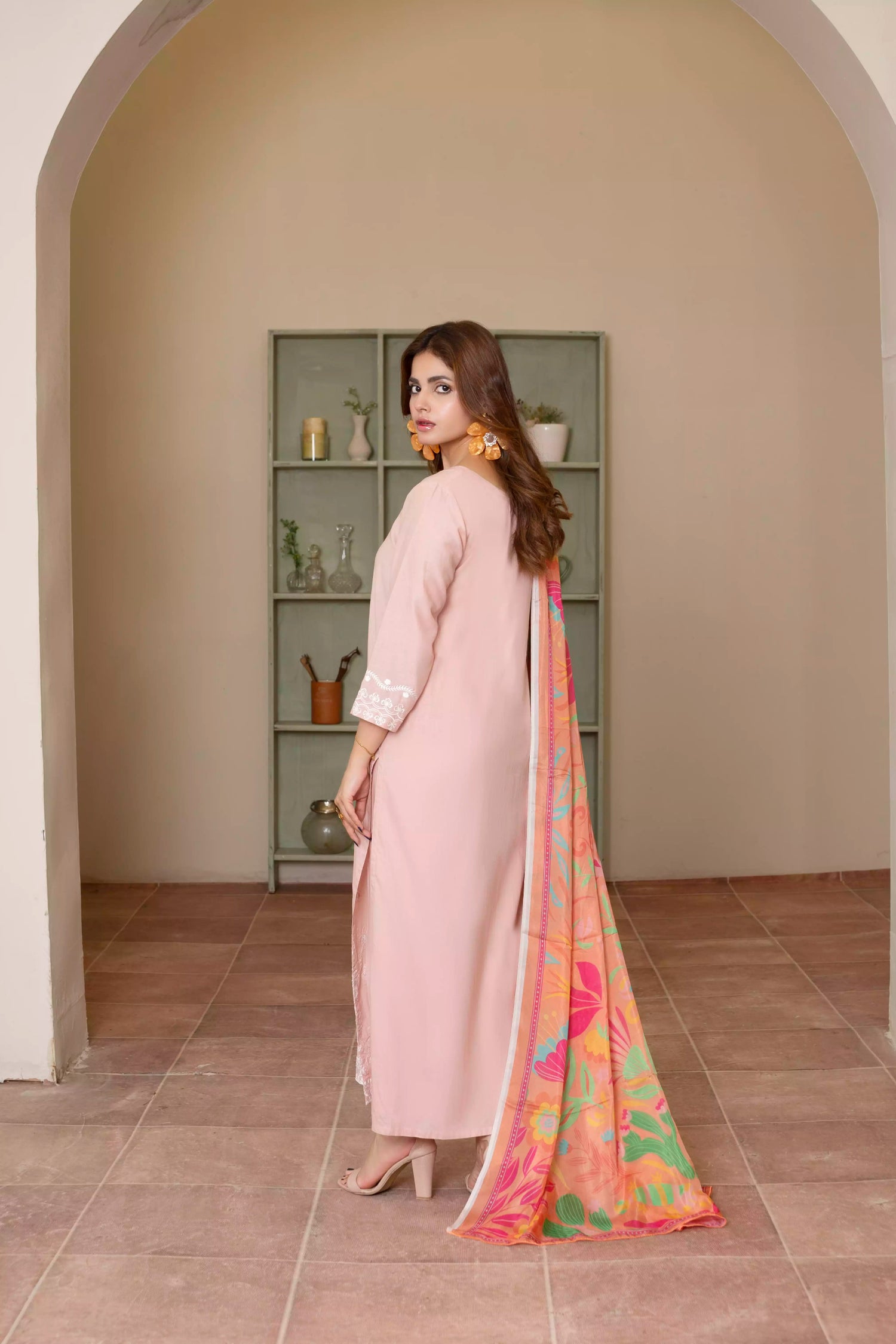 Soft pink embroidered suit with white floral motifs, matching trousers, and a vibrant multicolor silk dupatta for summer elegance.