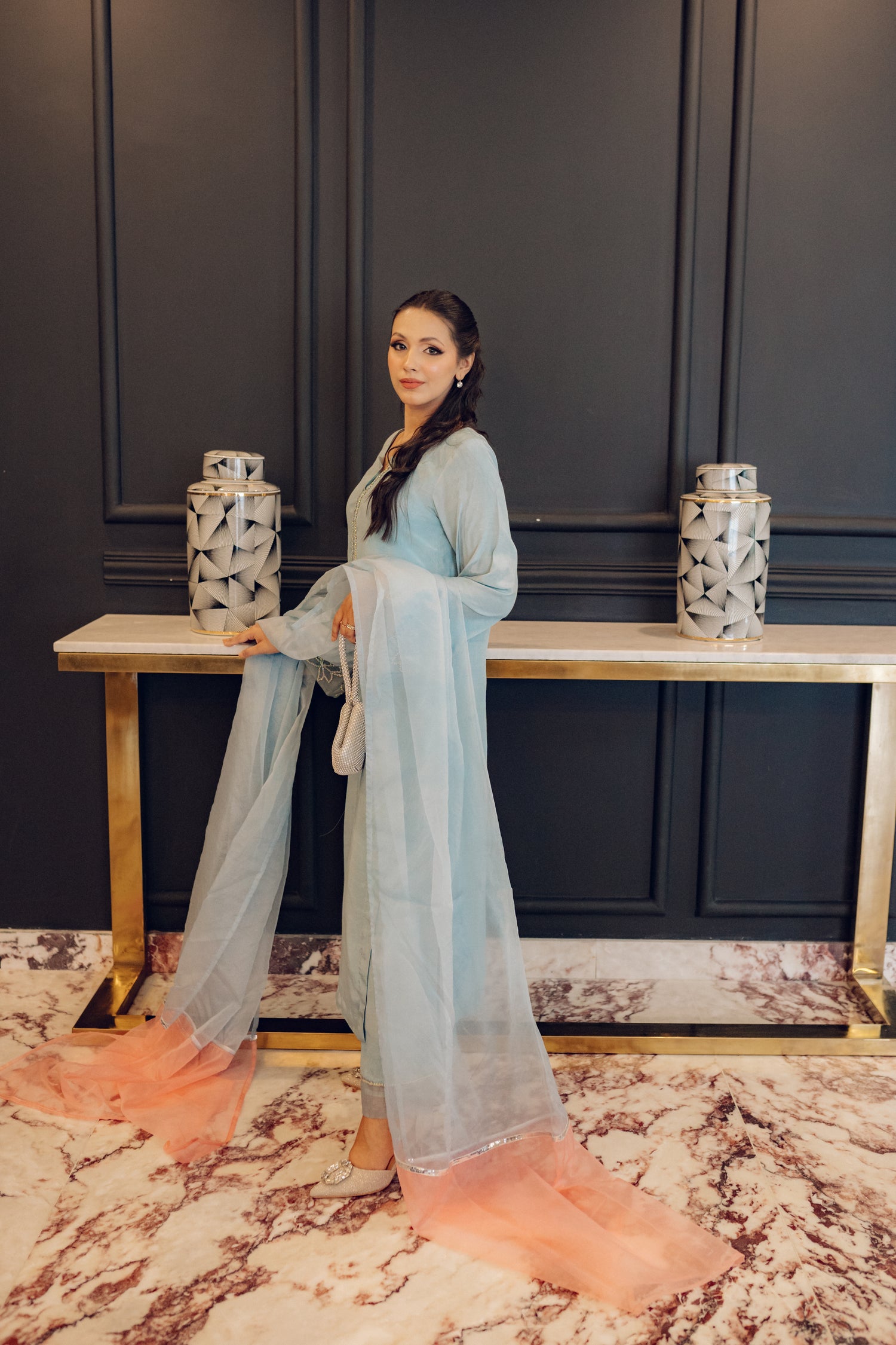 A flowing ice blue dress adorned with rhinestones showcasing elegance and style.