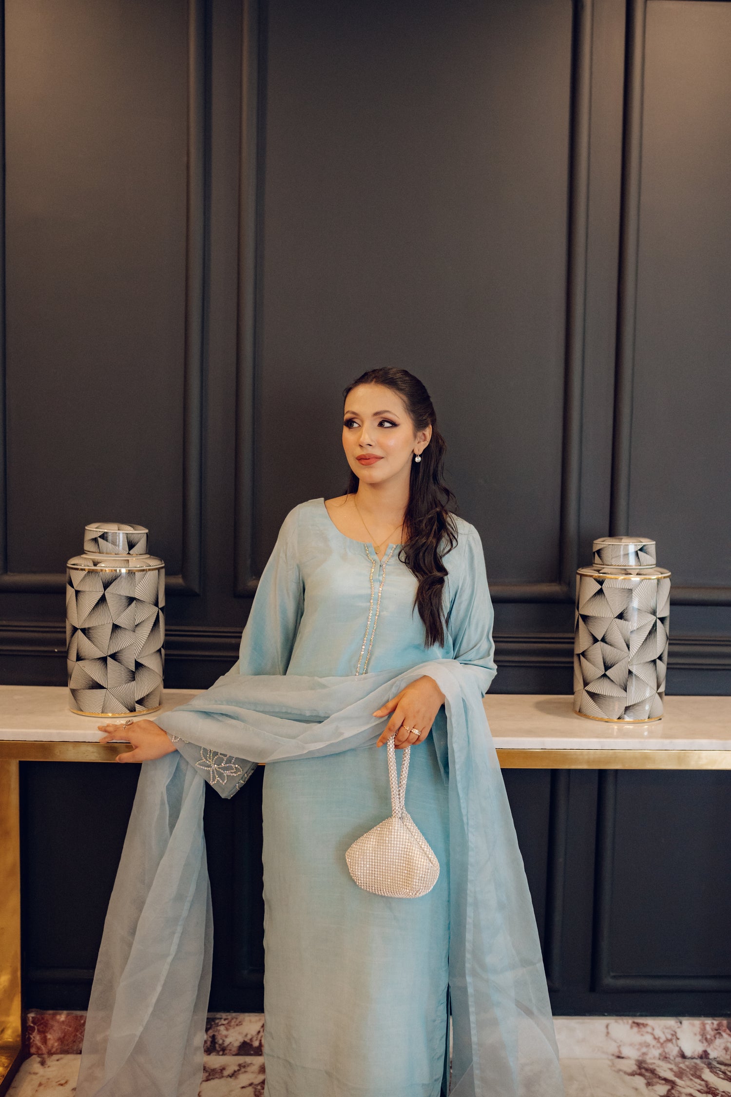 A flowing ice blue dress adorned with rhinestones showcasing elegance and style.