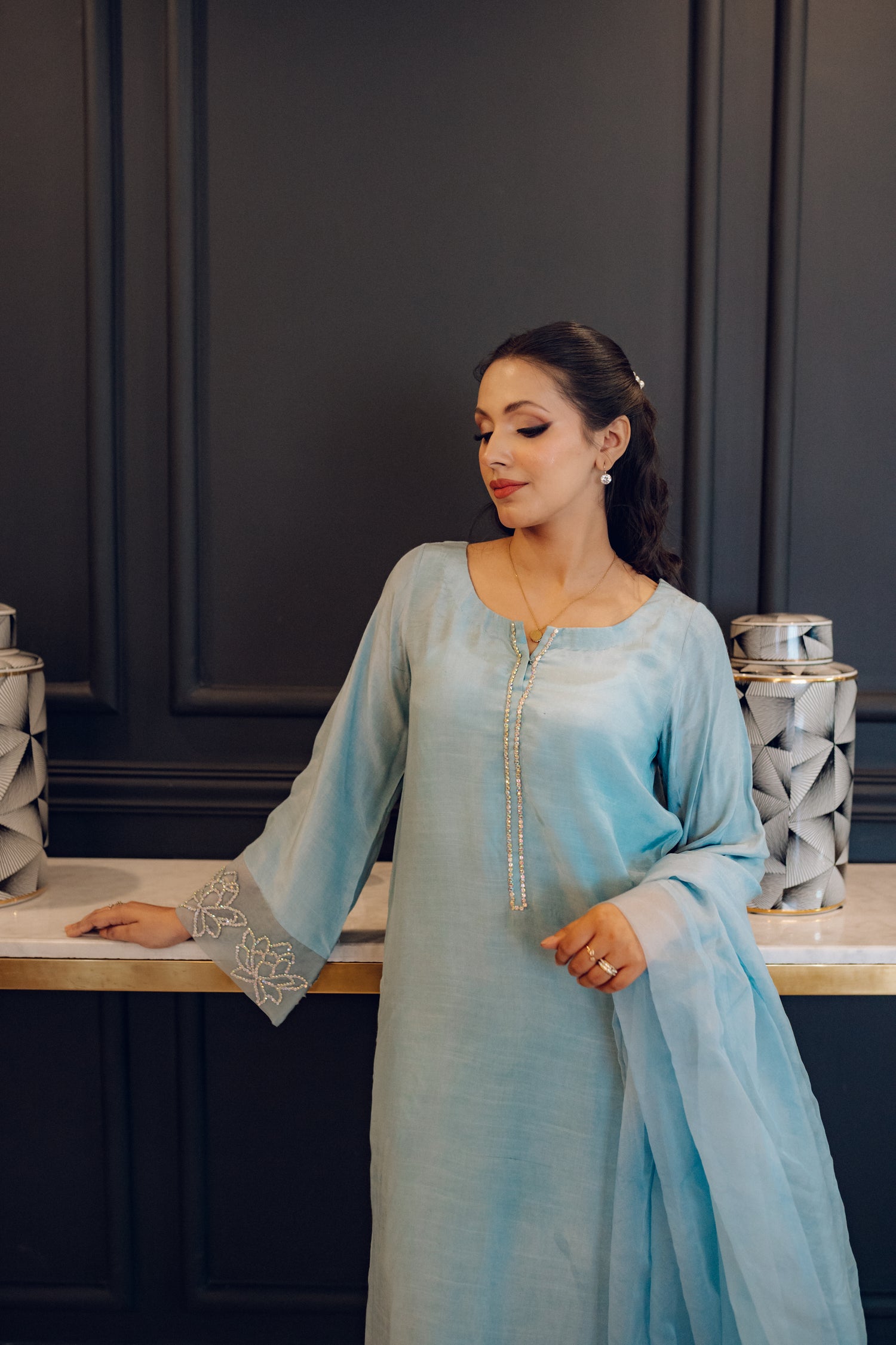 A flowing ice blue dress adorned with rhinestones showcasing elegance and style.