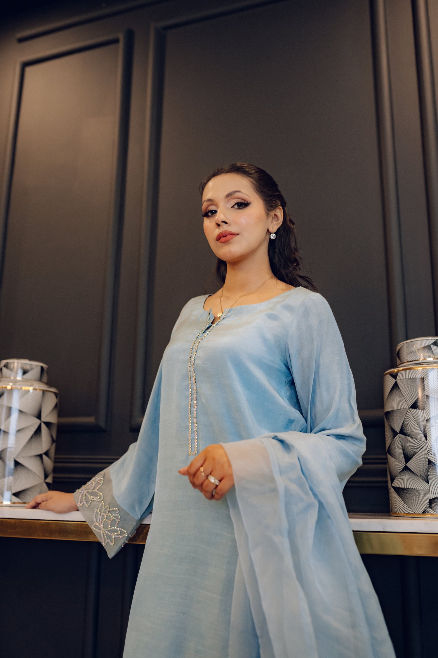 A flowing ice blue dress adorned with rhinestones showcasing elegance and style.