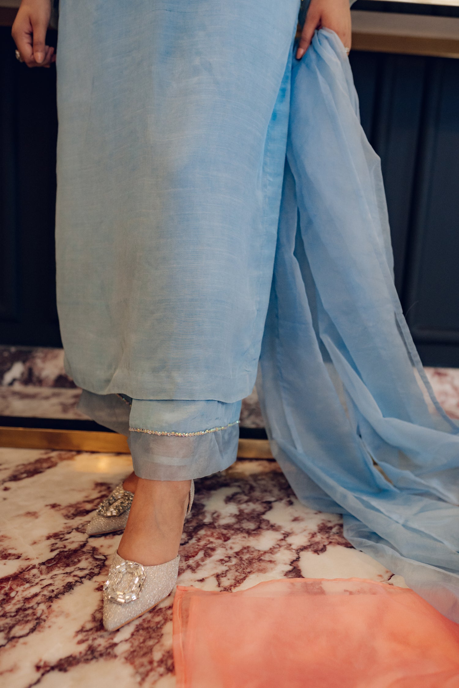A flowing ice blue dress adorned with rhinestones showcasing elegance and style.