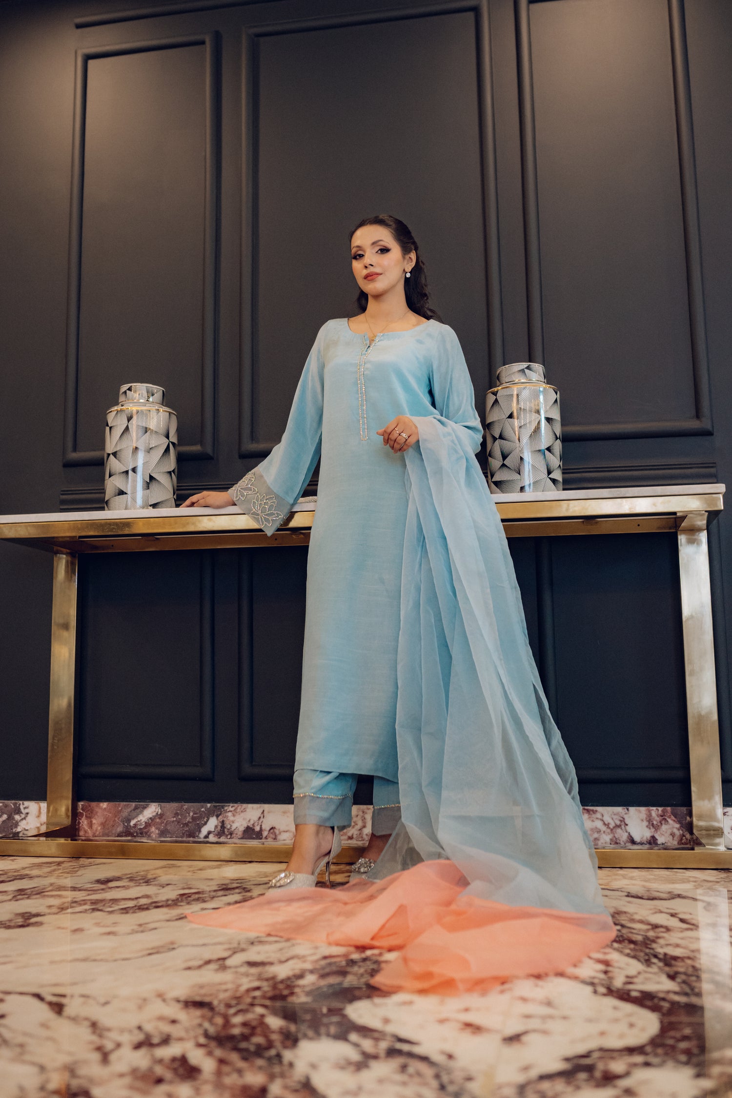 A flowing ice blue dress adorned with rhinestones showcasing elegance and style.