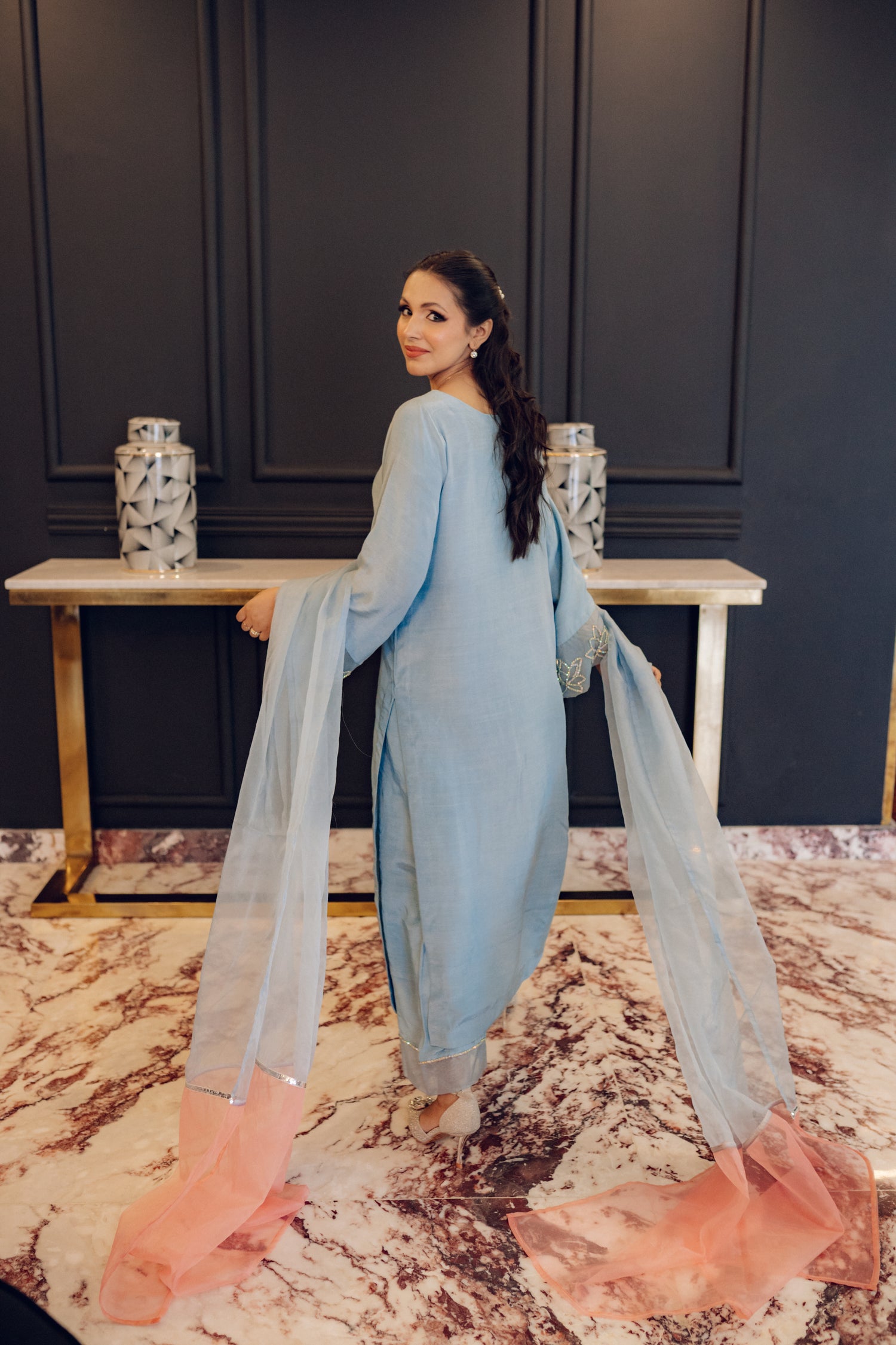 A flowing ice blue dress adorned with rhinestones showcasing elegance and style.