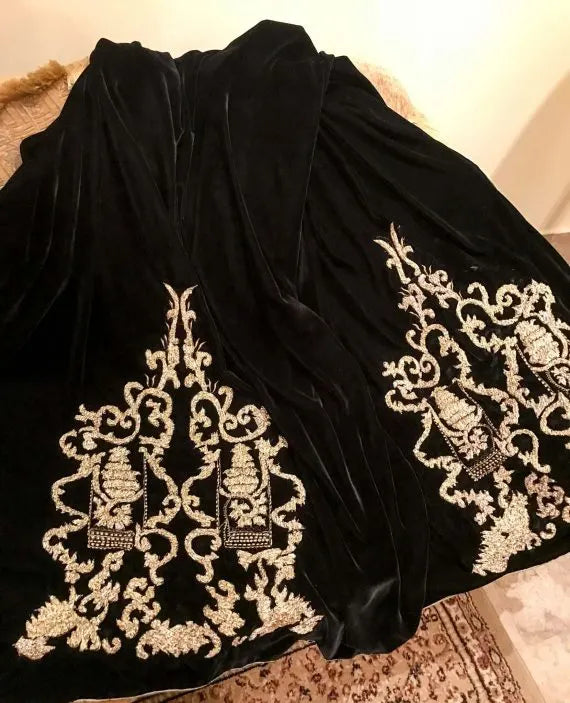 A stunning velvet shawl highlighting the exquisite Gota Embroidered work motif. Its intricate design work makes it ideal for weddings and festive wear.