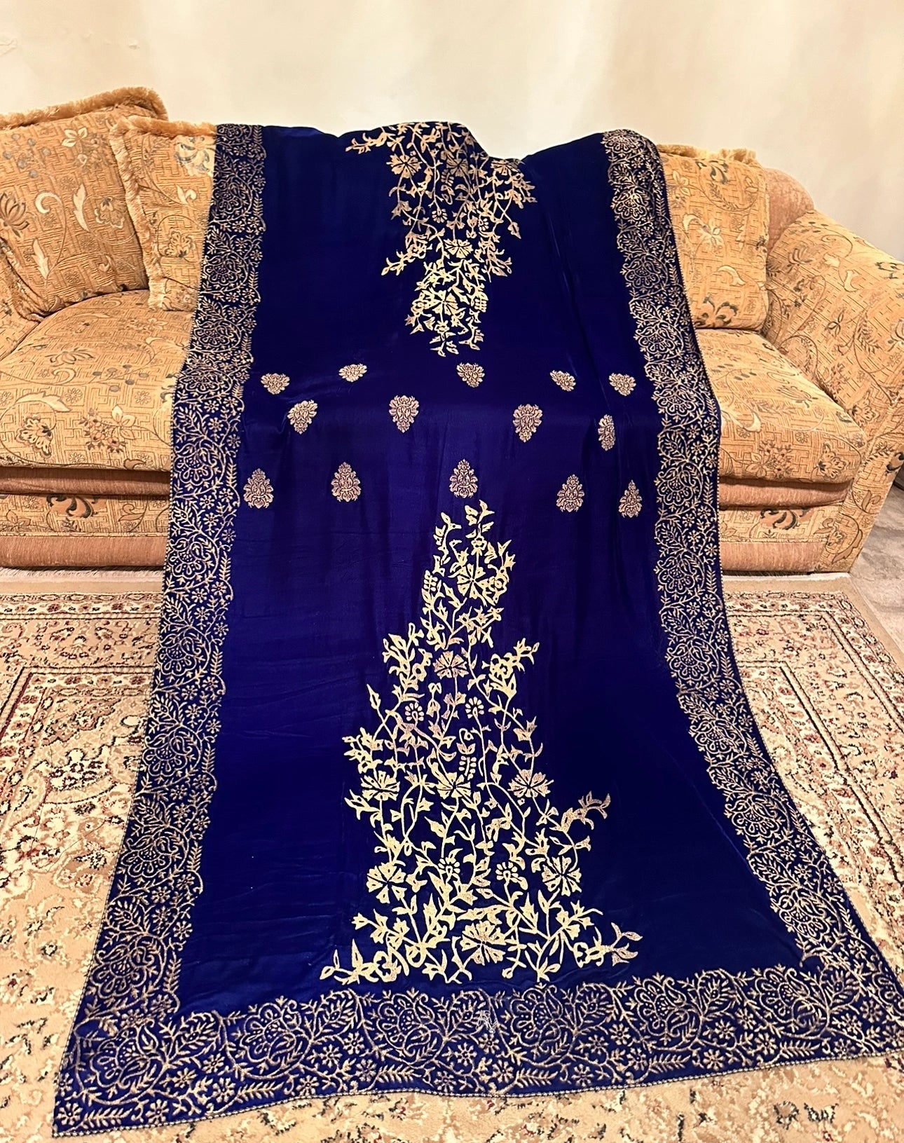 A black and gold shawl, showcasing intricate floral motifs, exuding elegance and warmth for festive occasions.