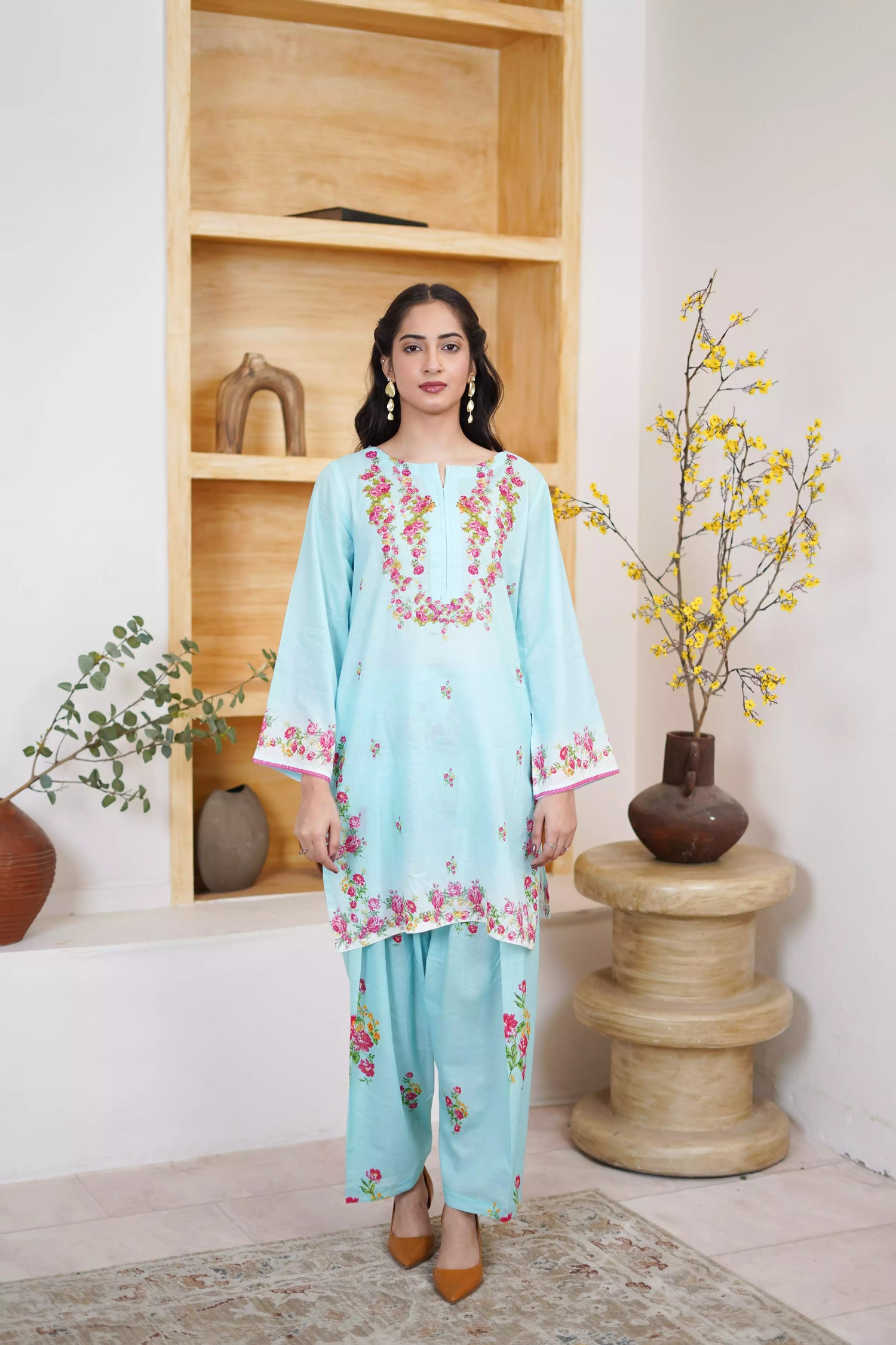 Bluebell Blossom 2-Piece Shalwar Kameez Set in a refreshing sky blue, featuring cascading floral print and a detailed border print at the hem. A blend of modern femininity.
