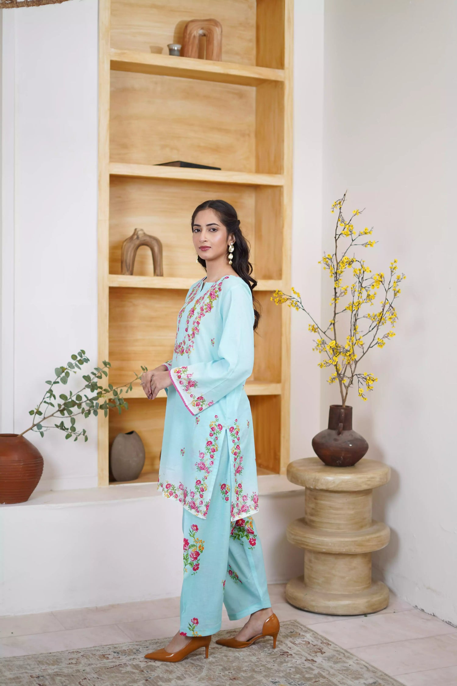 Bluebell Blossom 2-Piece Shalwar Kameez Set in a refreshing sky blue, featuring cascading floral print and a detailed border print at the hem. A blend of modern femininity.