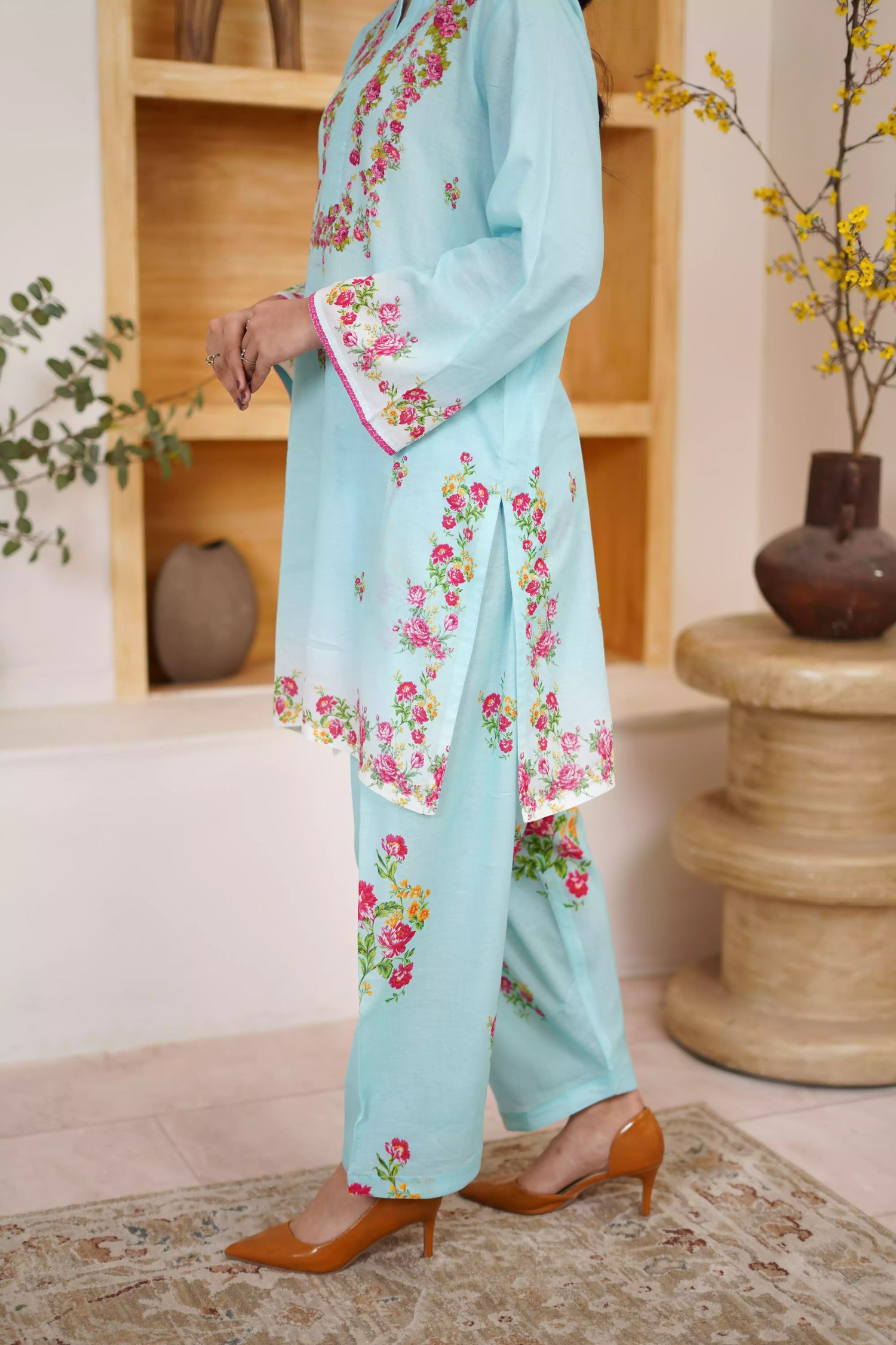 Bluebell Blossom 2-Piece Shalwar Kameez Set in a refreshing sky blue, featuring cascading floral print and a detailed border print at the hem. A blend of modern femininity.