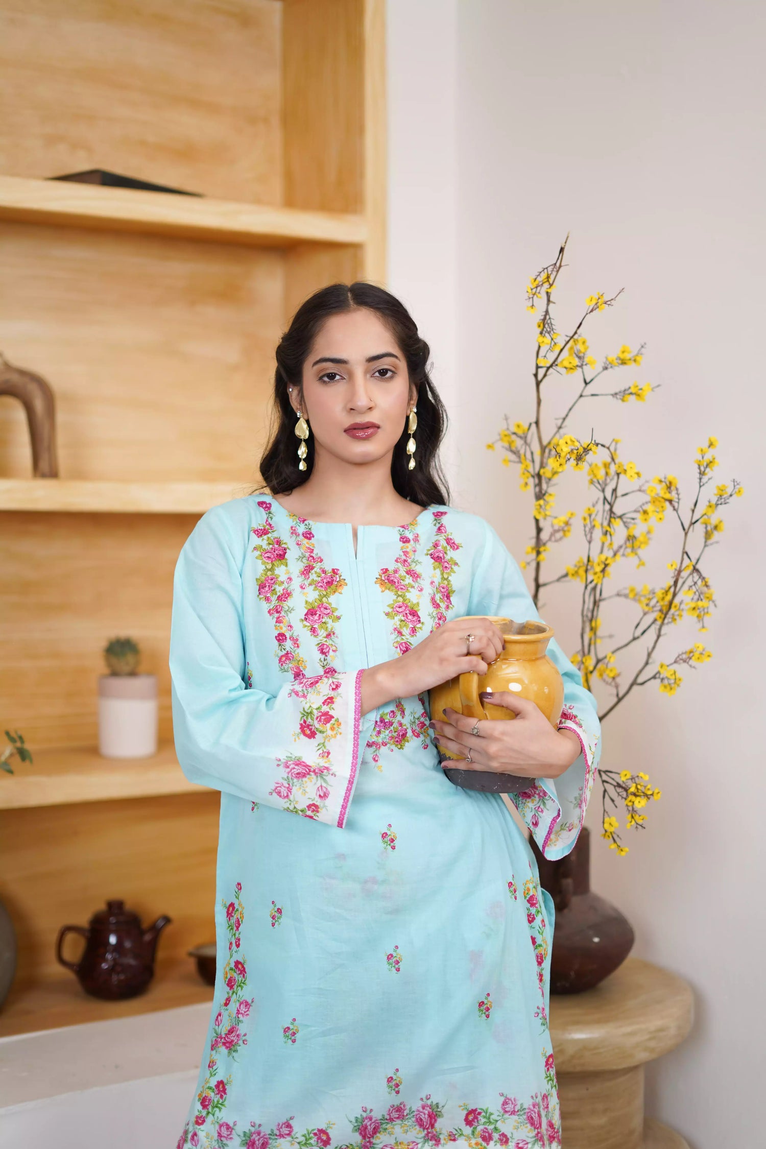 Bluebell Blossom 2-Piece Shalwar Kameez Set in a refreshing sky blue, featuring cascading floral print and a detailed border print at the hem. A blend of modern femininity.
