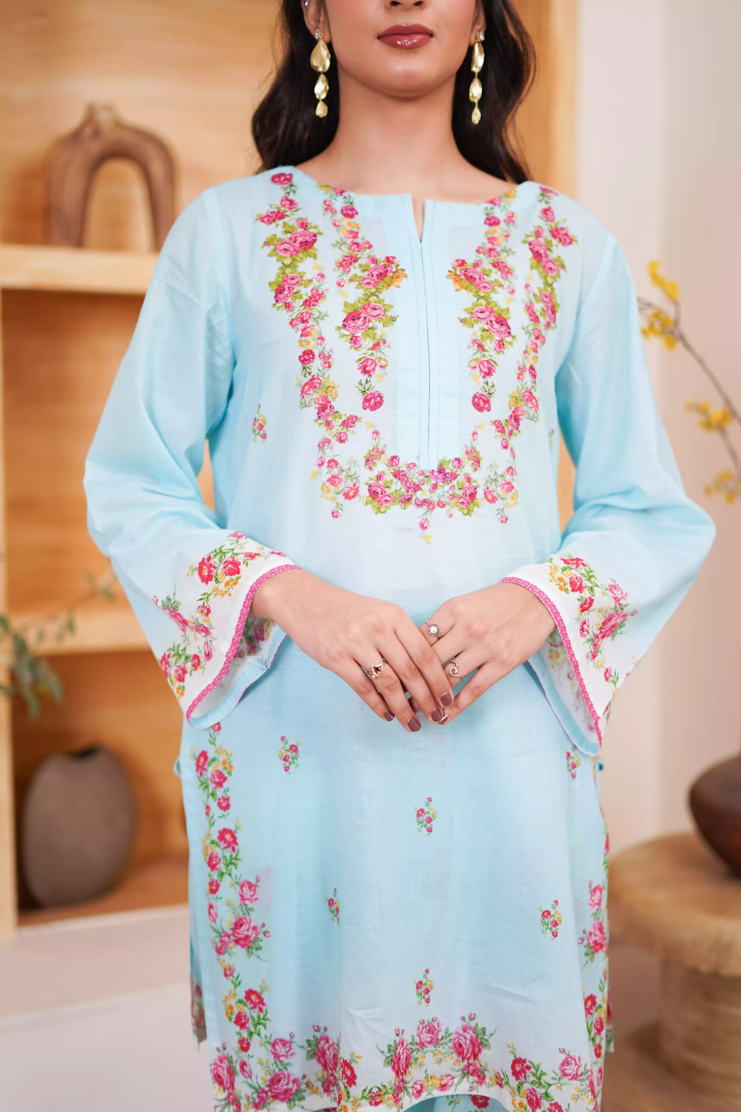 Bluebell Blossom 2-Piece Shalwar Kameez Set in a refreshing sky blue, featuring cascading floral print and a detailed border print at the hem. A blend of modern femininity.