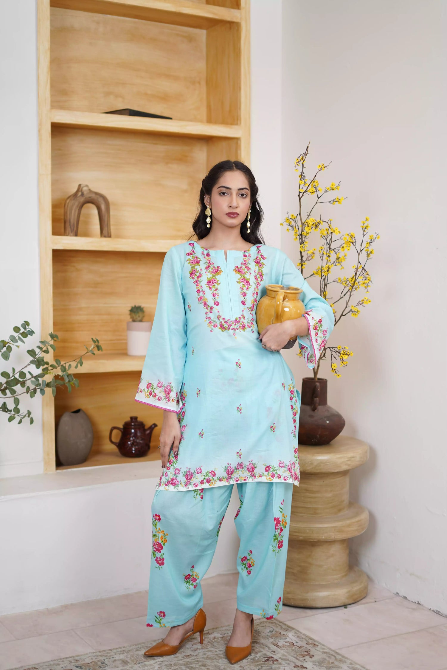 Bluebell Blossom 2-Piece Shalwar Kameez Set in a refreshing sky blue, featuring cascading floral print and a detailed border print at the hem. A blend of modern femininity.