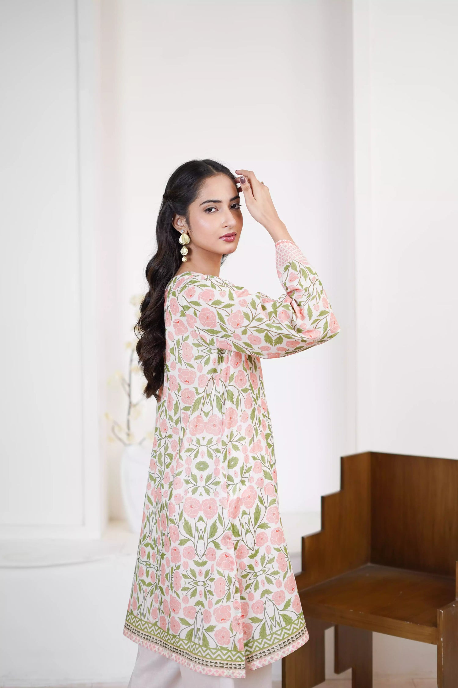 A pink and green suit featuring a floral design on cream, paired with light pink printed trousers exuding timeless elegance.