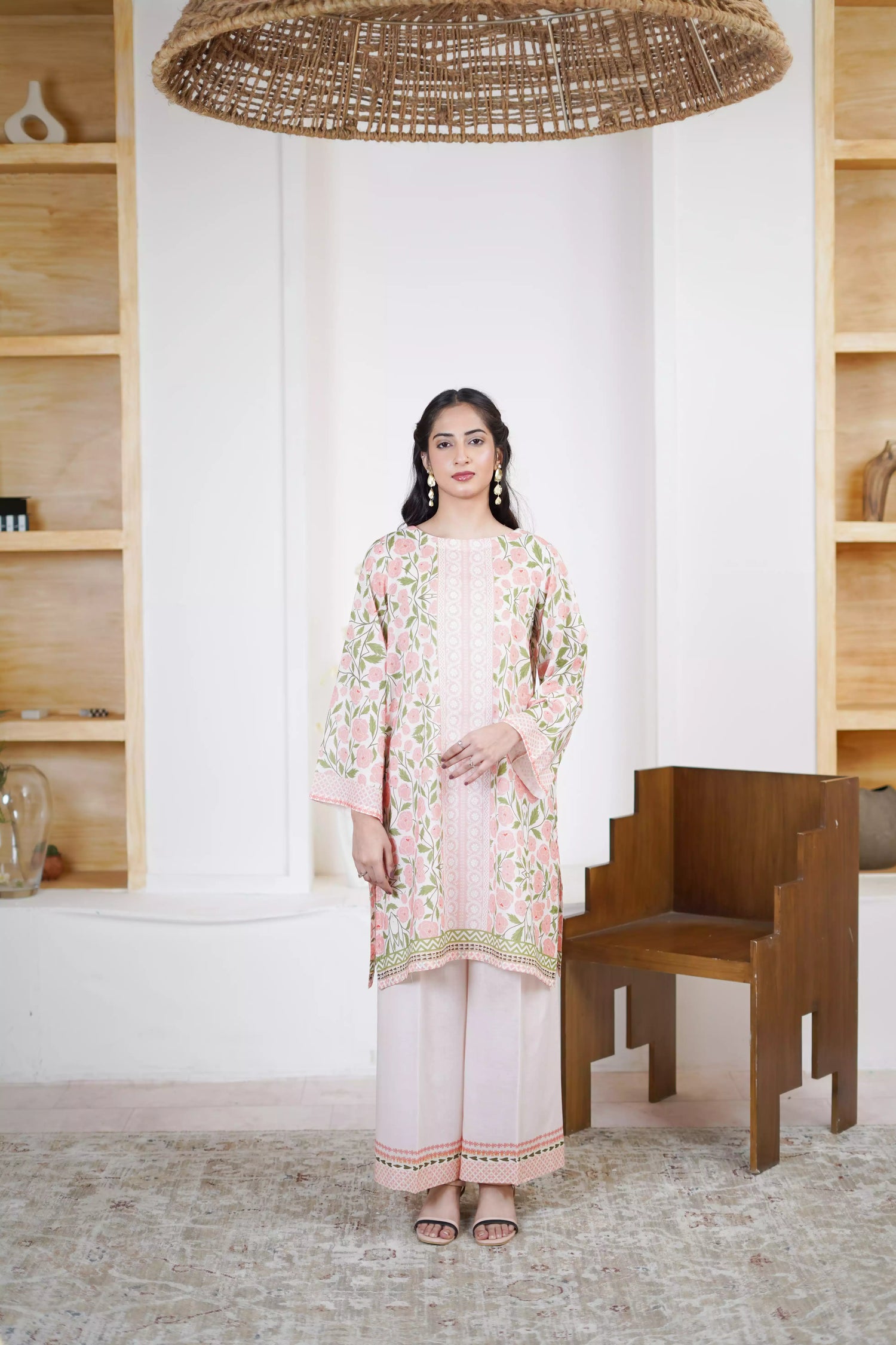 A pink and green suit featuring a floral design on cream, paired with light pink printed trousers exuding timeless elegance.