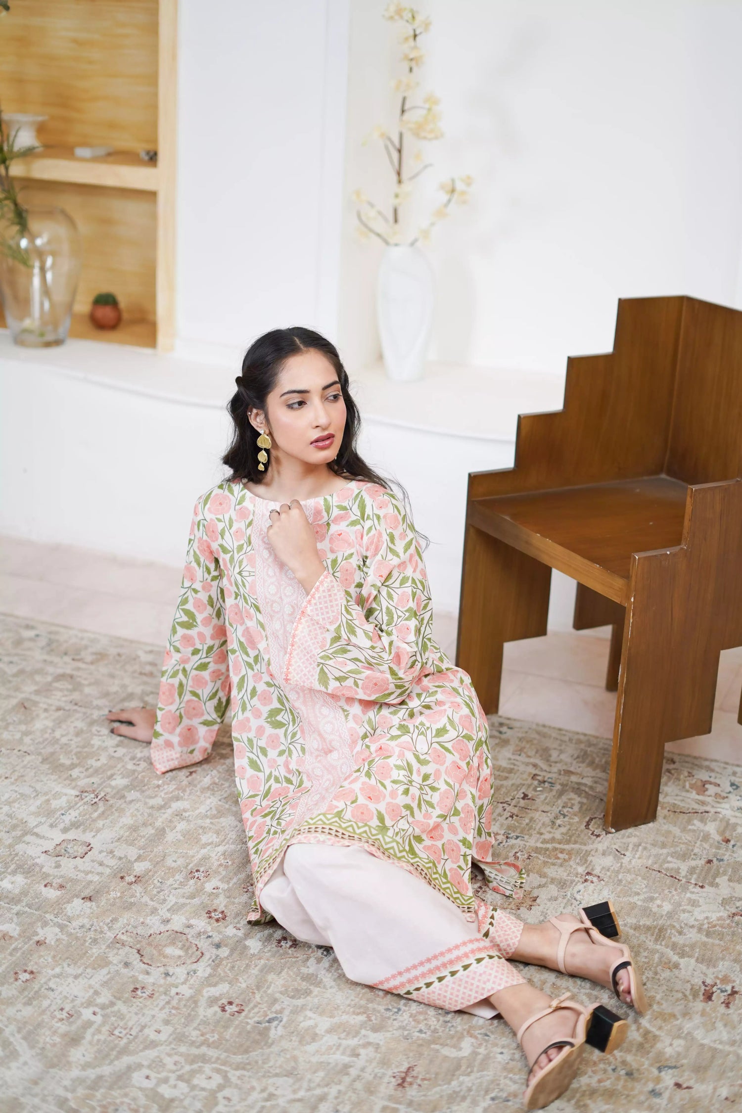 A pink and green suit featuring a floral design on cream, paired with light pink printed trousers exuding timeless elegance.