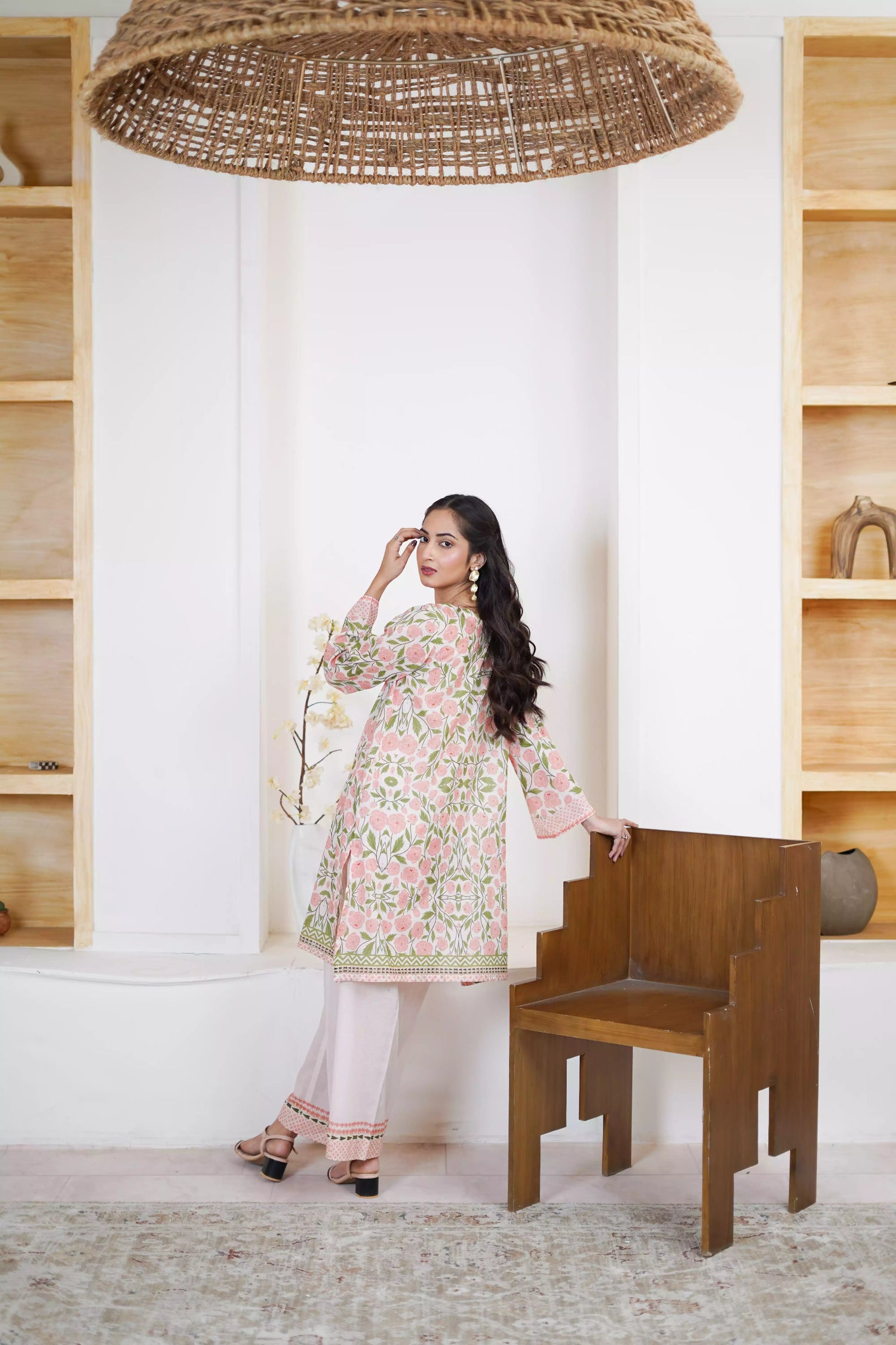 A pink and green suit featuring a floral design on cream, paired with light pink printed trousers exuding timeless elegance.