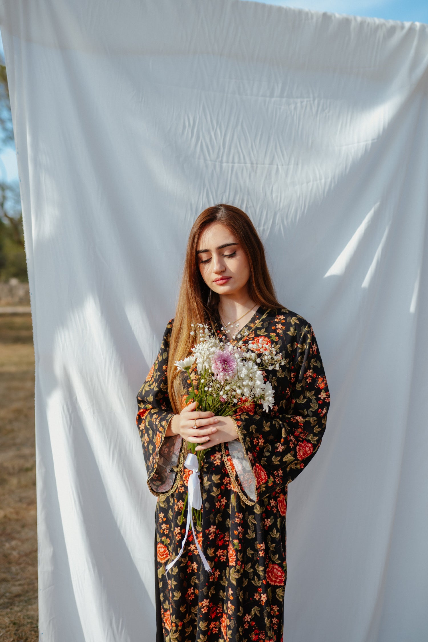 Black ethnic outfit made from soft fabric. Features gold-toned festive wear with floral patterns.