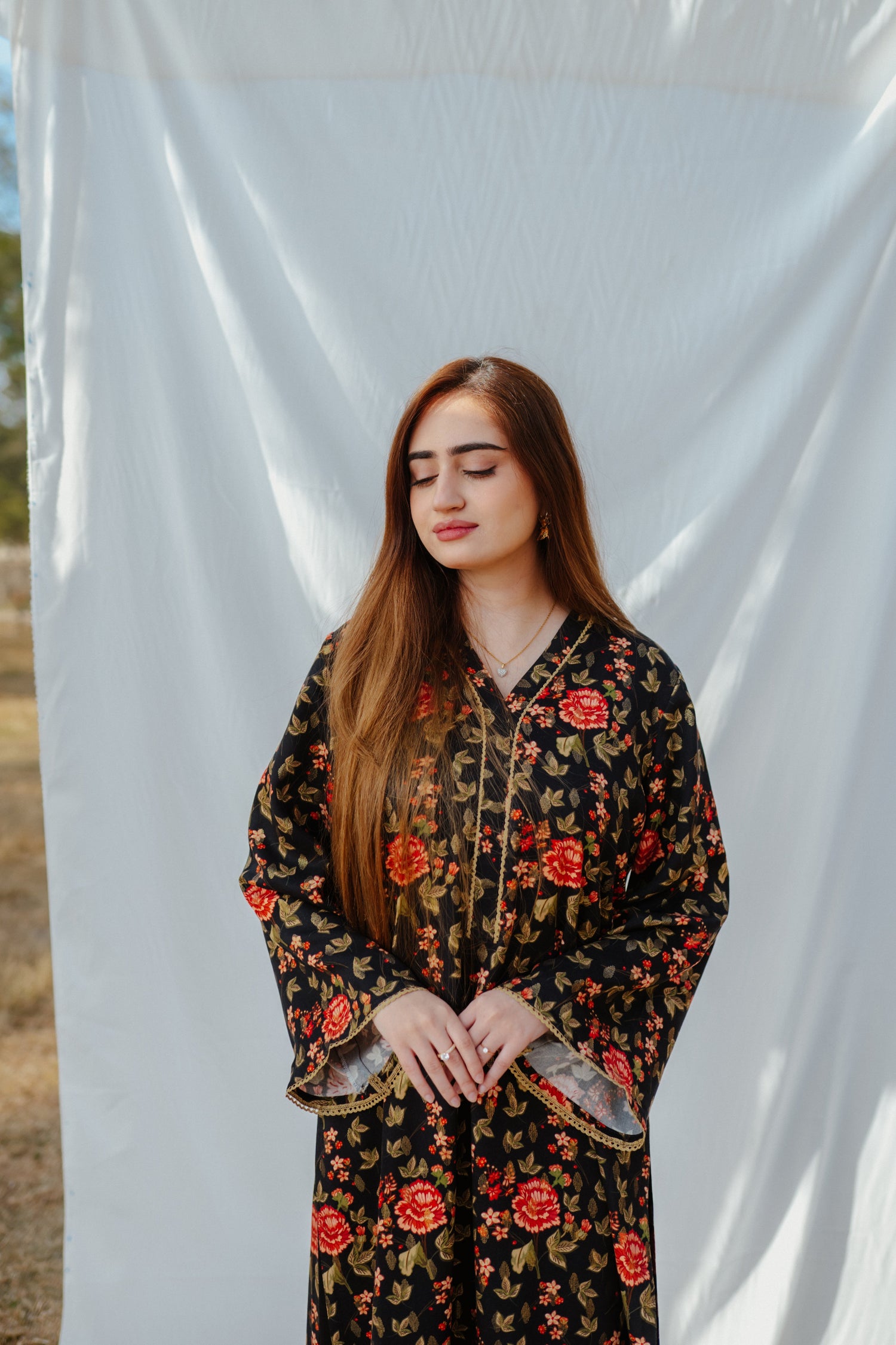Black ethnic outfit made from soft fabric. Features gold-toned festive wear with floral patterns.
