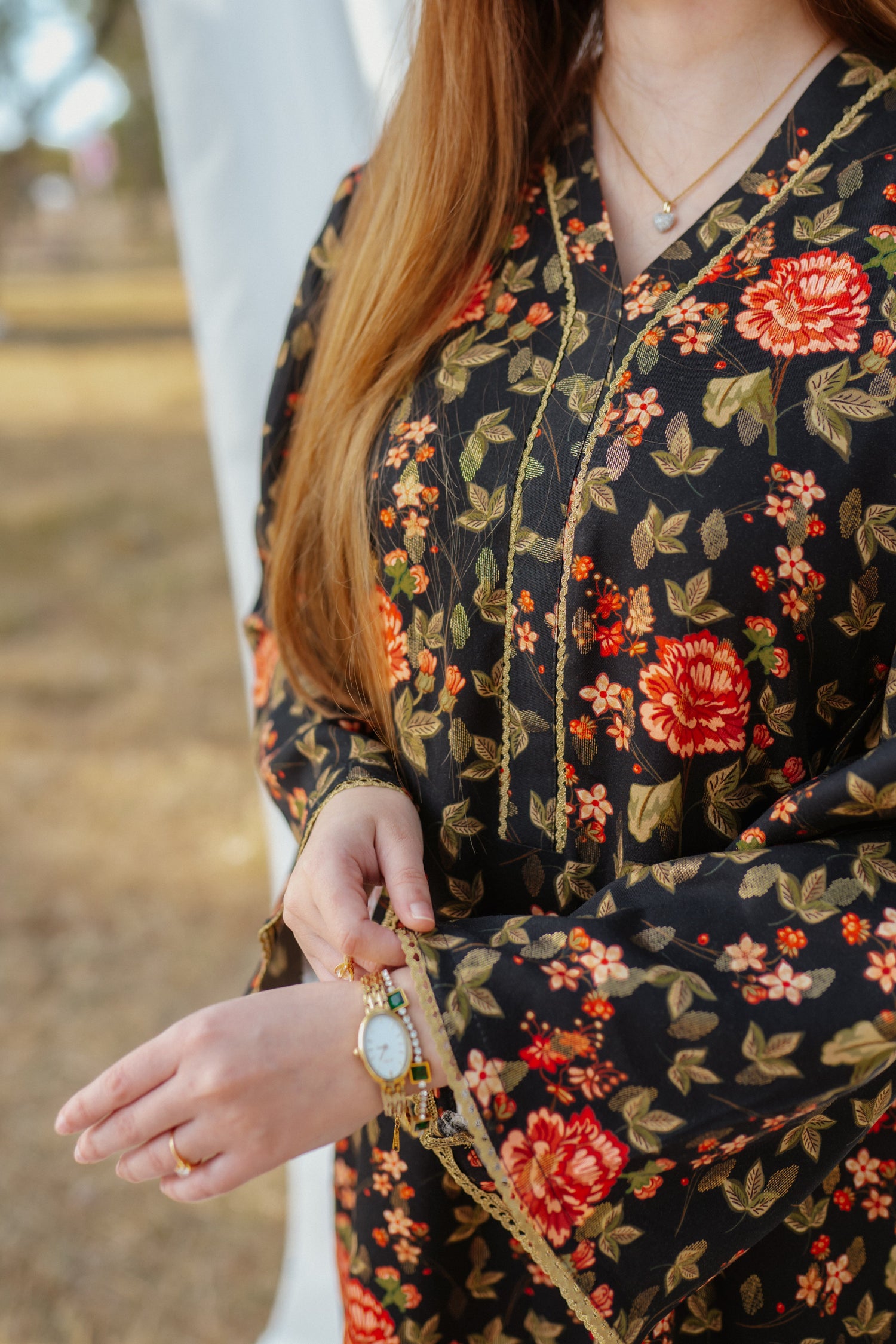 Black ethnic outfit made from soft fabric. Features gold-toned festive wear with floral patterns.