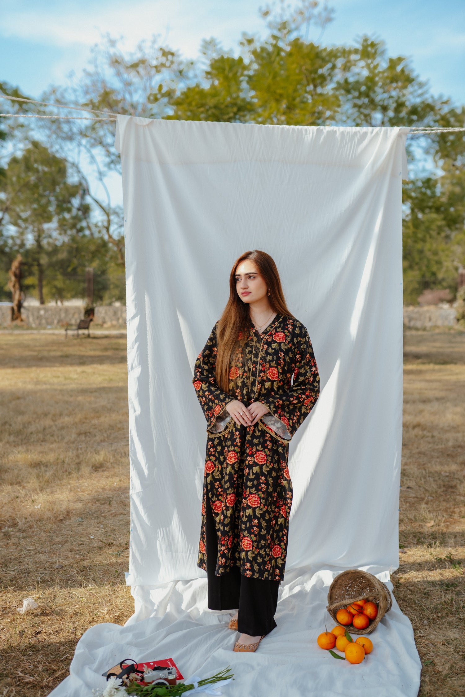 Black ethnic outfit made from soft fabric. Features gold-toned festive wear with floral patterns.