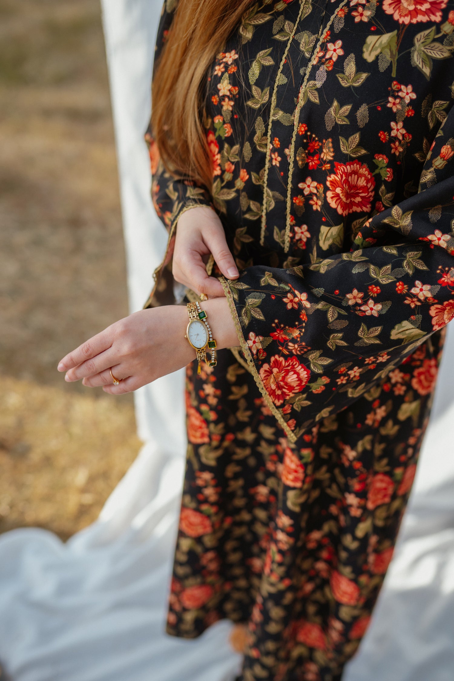Black ethnic outfit made from soft fabric. Features gold-toned festive wear with floral patterns.