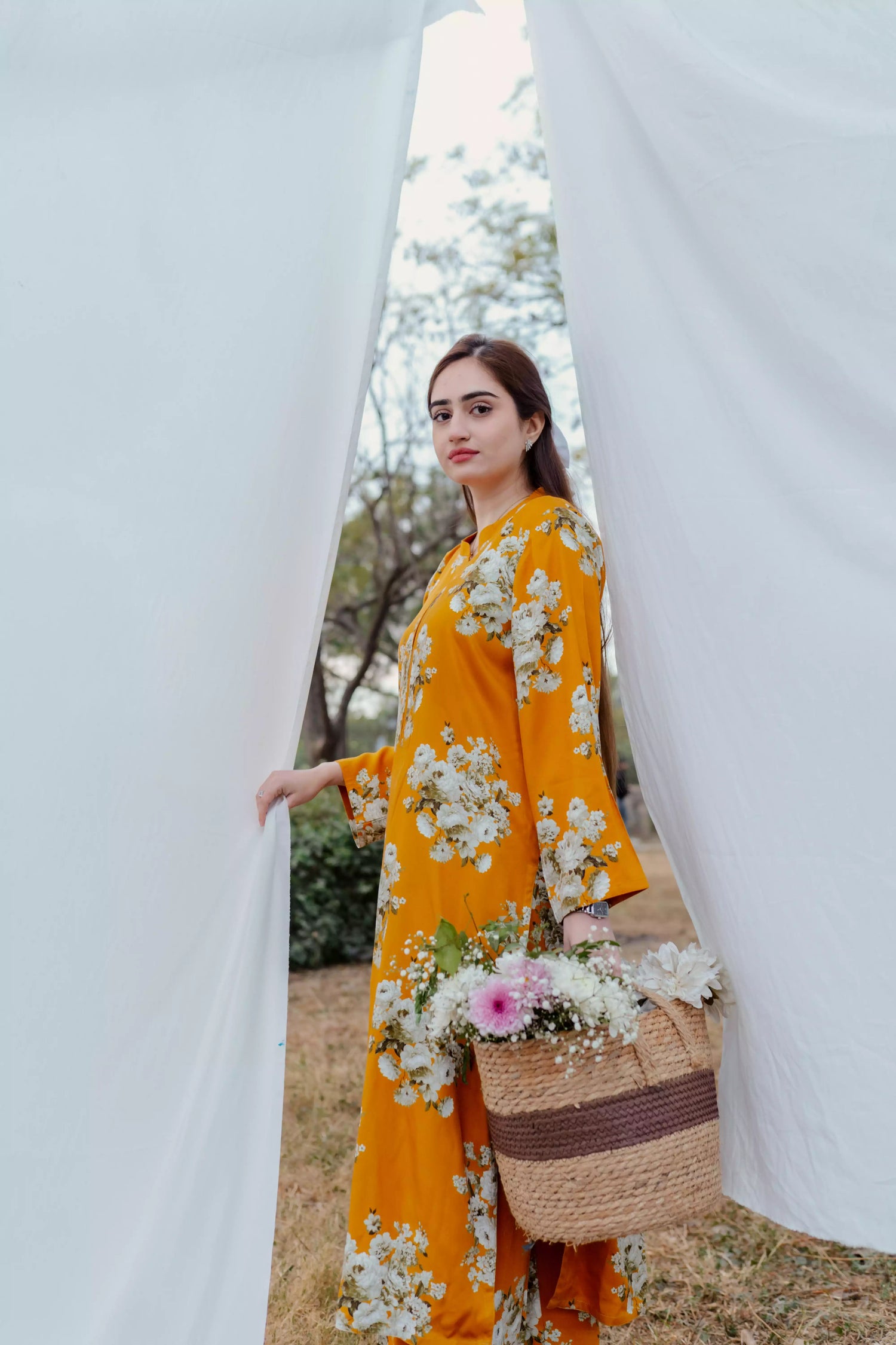 Yellow floral two-piece suit with long shirt and flared pants, styled for casual and semi-formal occasions.