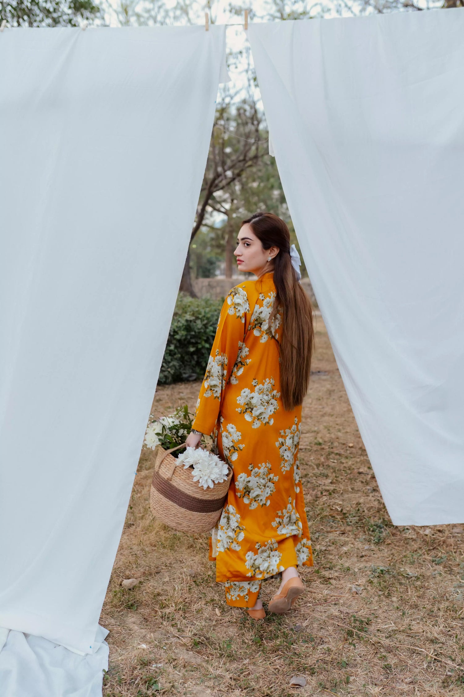 Yellow floral two-piece suit with long shirt and flared pants, styled for casual and semi-formal occasions.