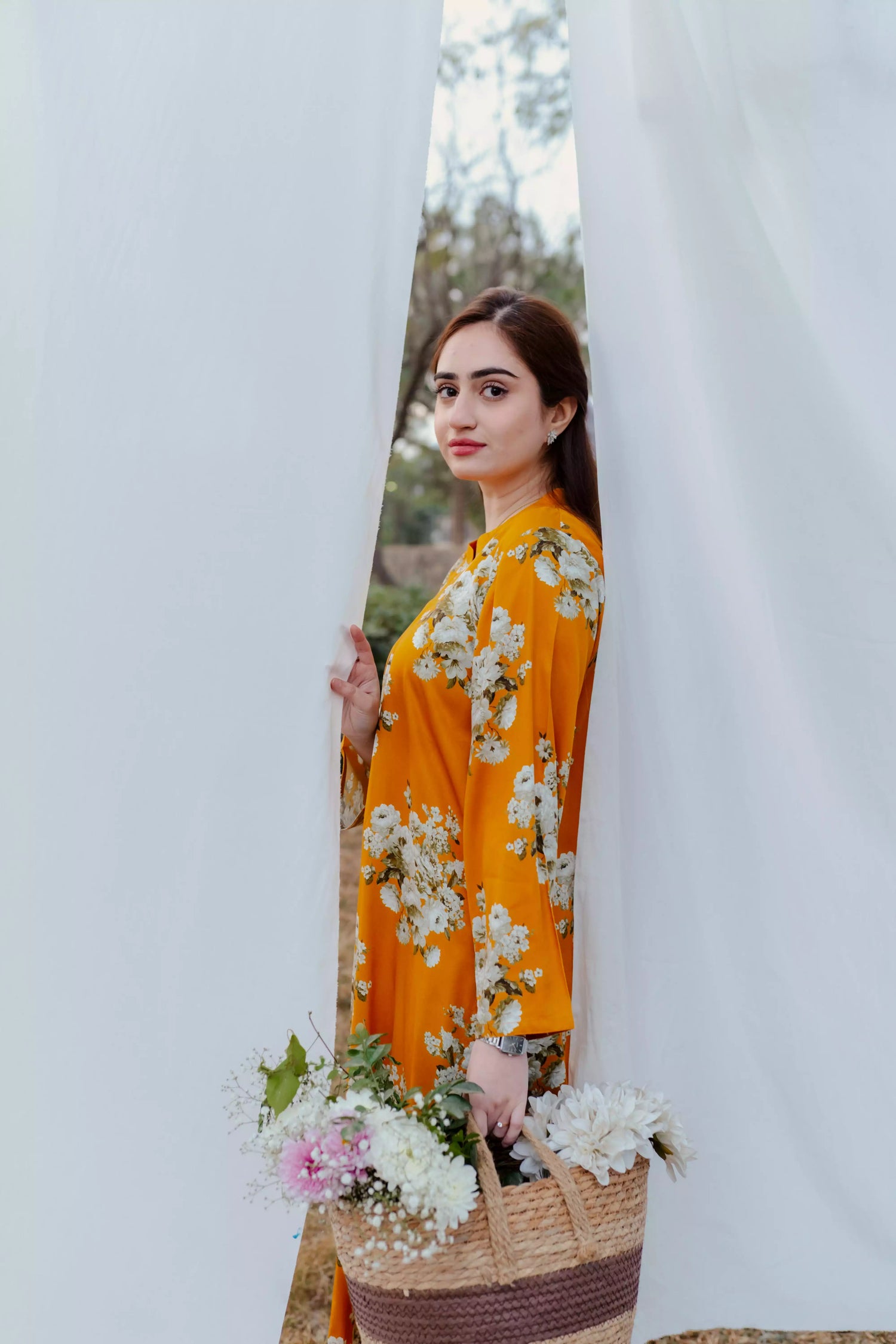 Yellow floral two-piece suit with long shirt and flared pants, styled for casual and semi-formal occasions.