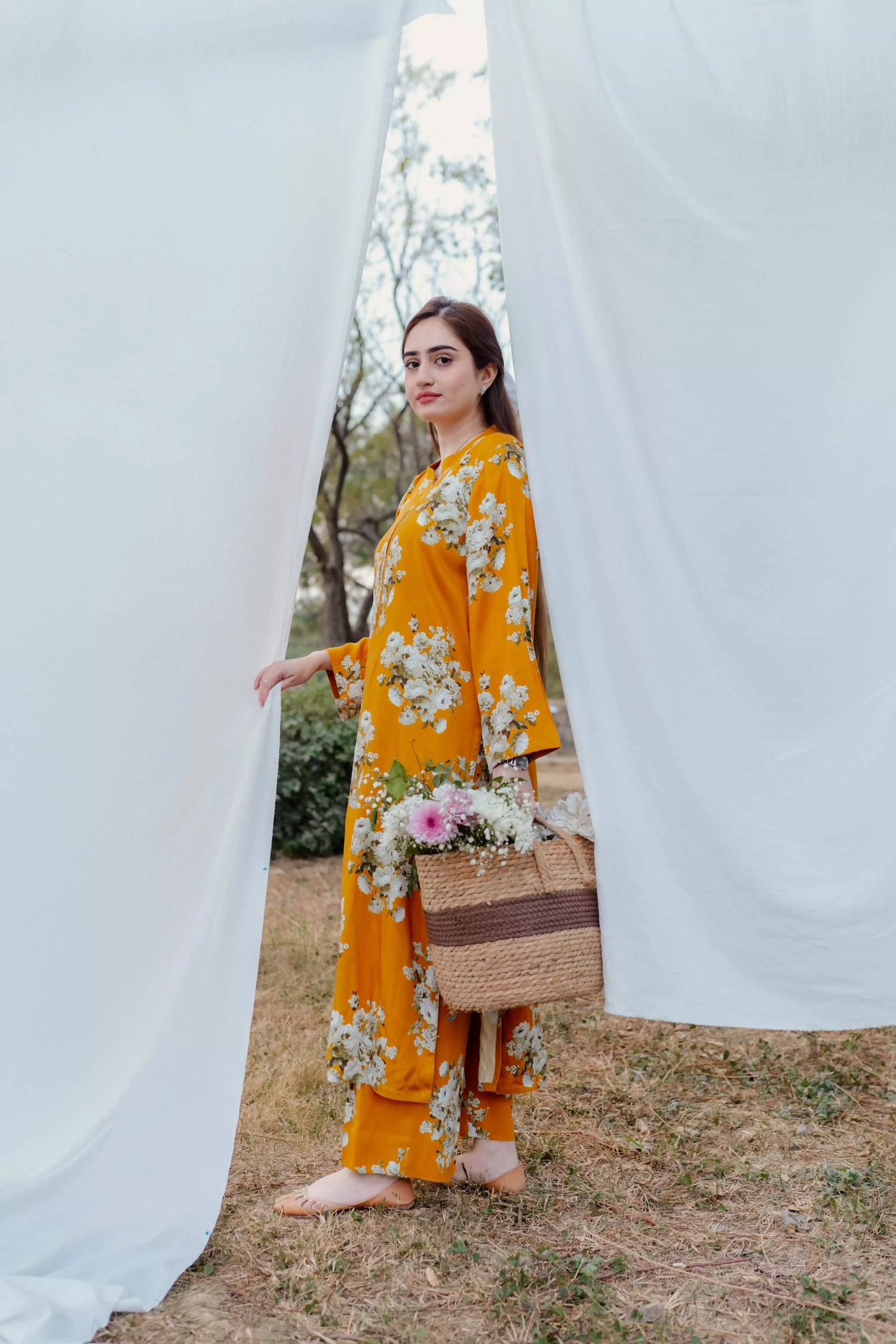 Yellow floral two-piece suit with long shirt and flared pants, styled for casual and semi-formal occasions.
