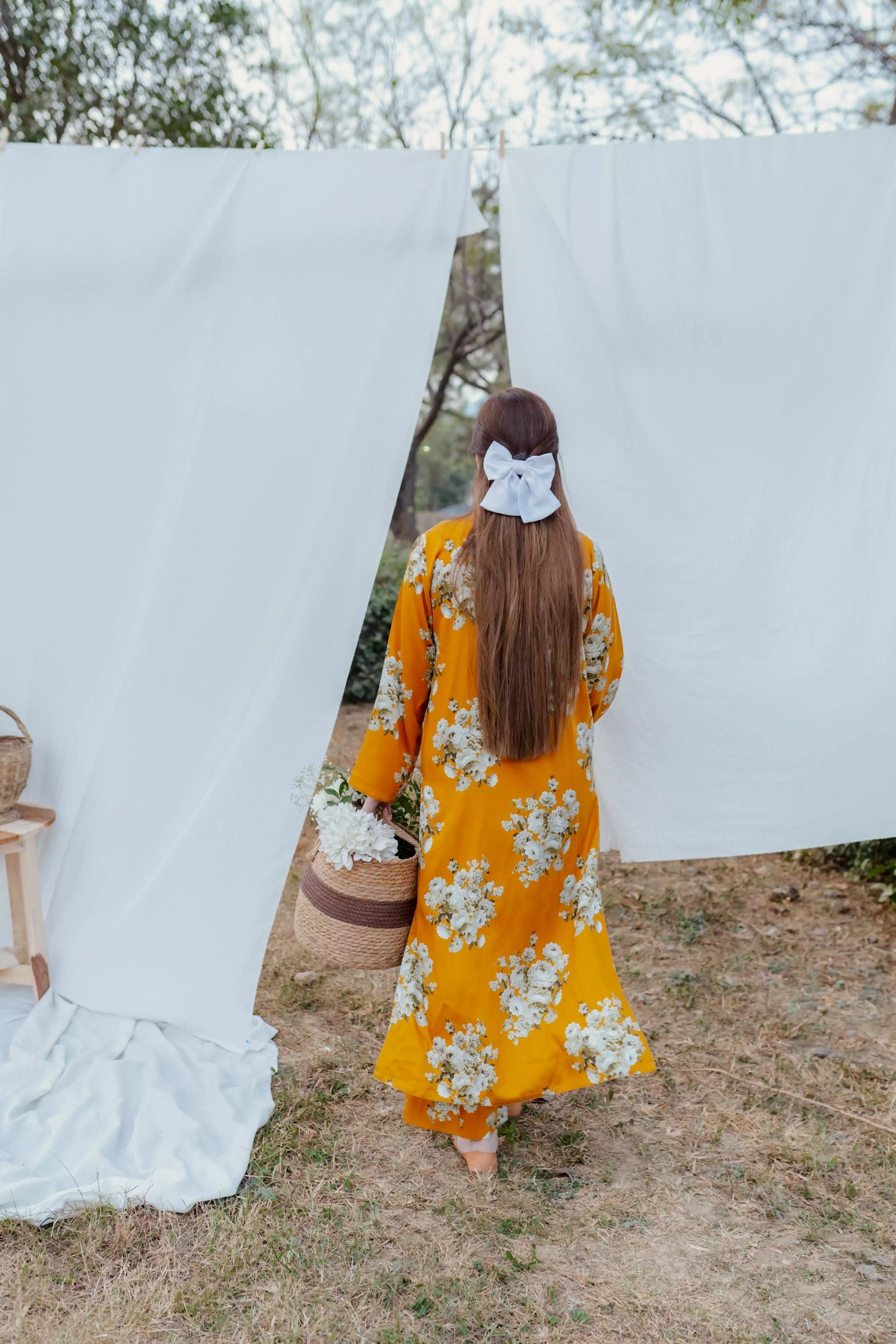 Yellow floral two-piece suit with long shirt and flared pants, styled for casual and semi-formal occasions.