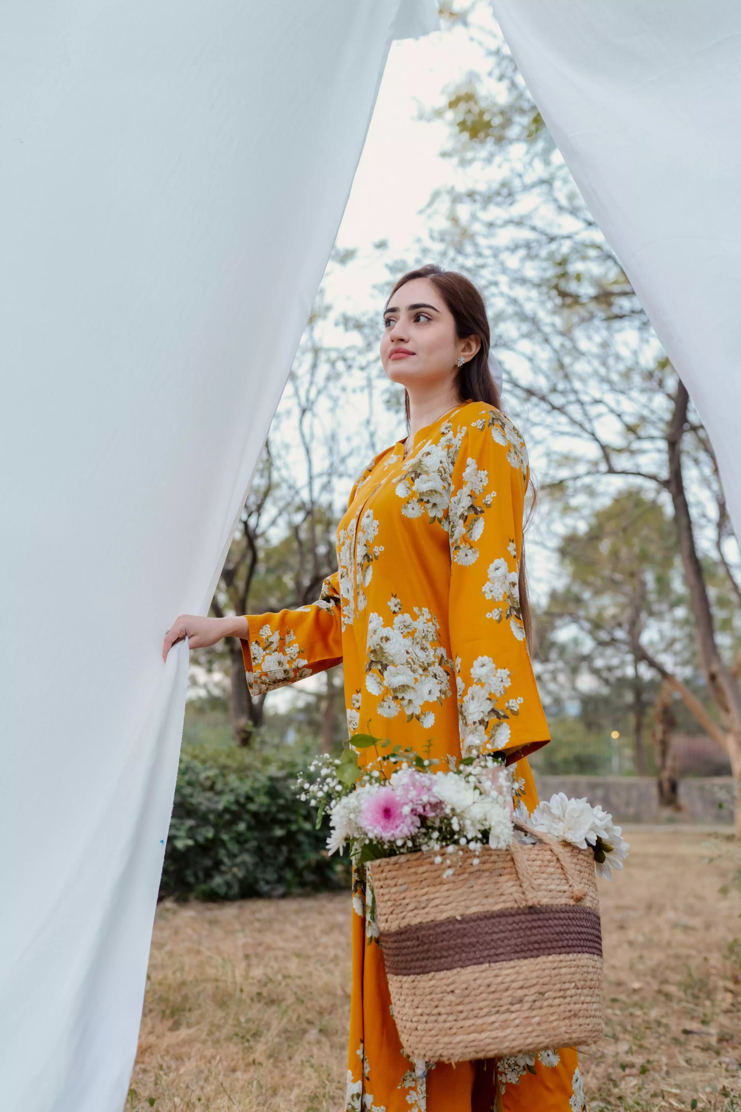 Yellow floral two-piece suit with long shirt and flared pants, styled for casual and semi-formal occasions.