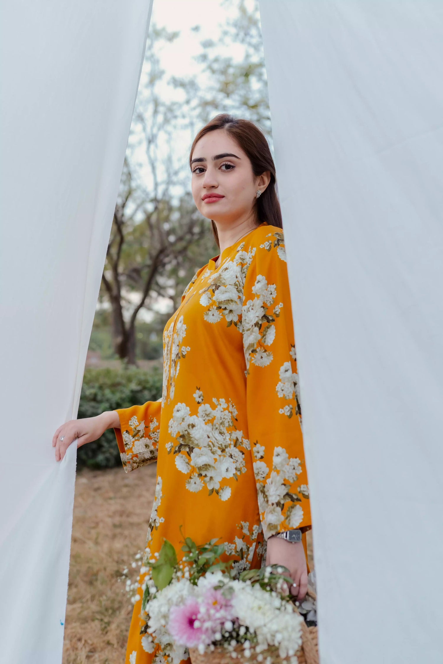 Yellow floral two-piece suit with long shirt and flared pants, styled for casual and semi-formal occasions.